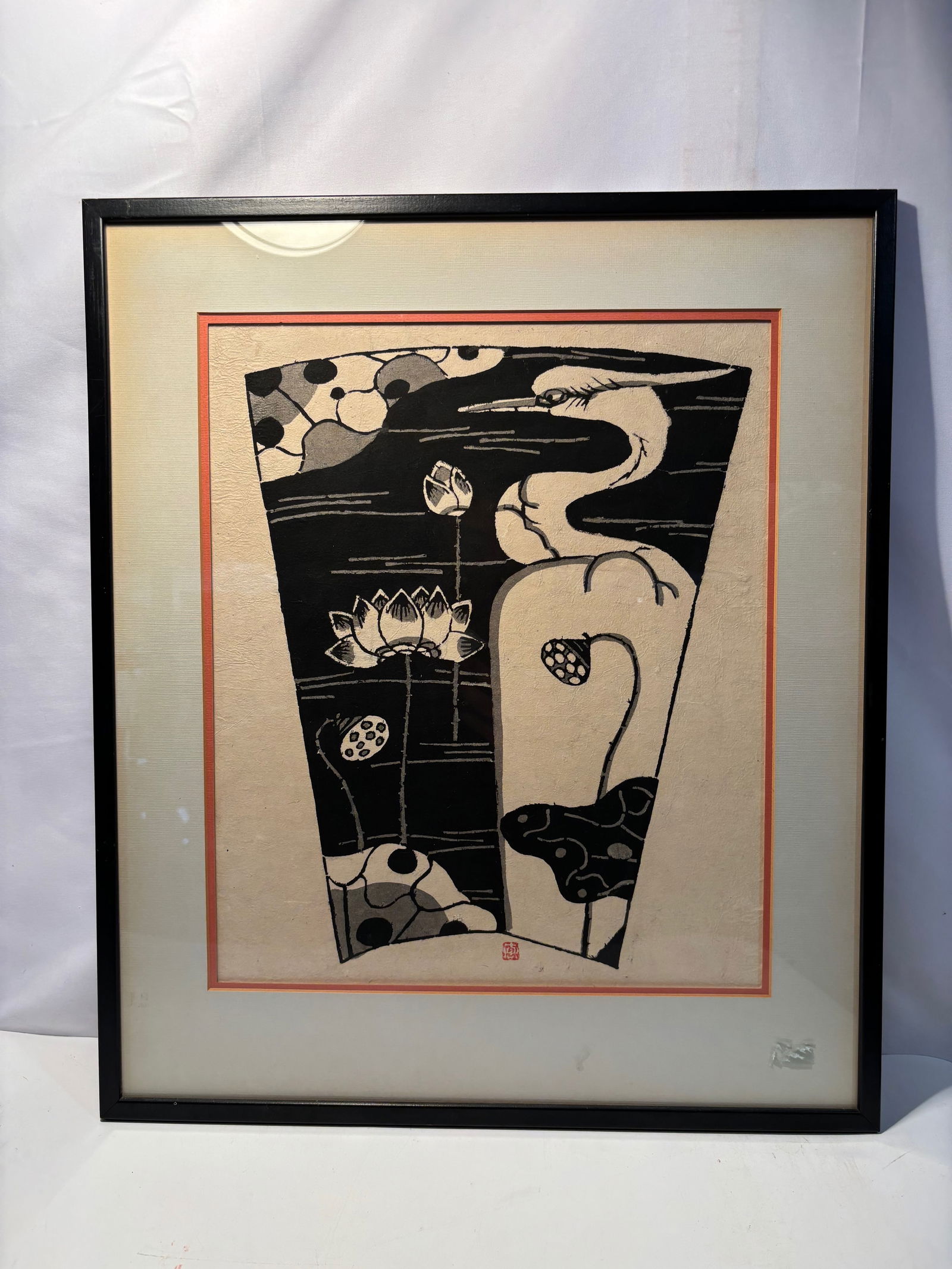 Japanese Modern Woodblock Print, Heron and Lotus, Signed with “Kei?? (?) Seal: Japanese modern woodblock print depicting a stylized heron among lotus blossoms and pods in a bold black and white composition. The design features strong graphic contrasts and simplified natural form