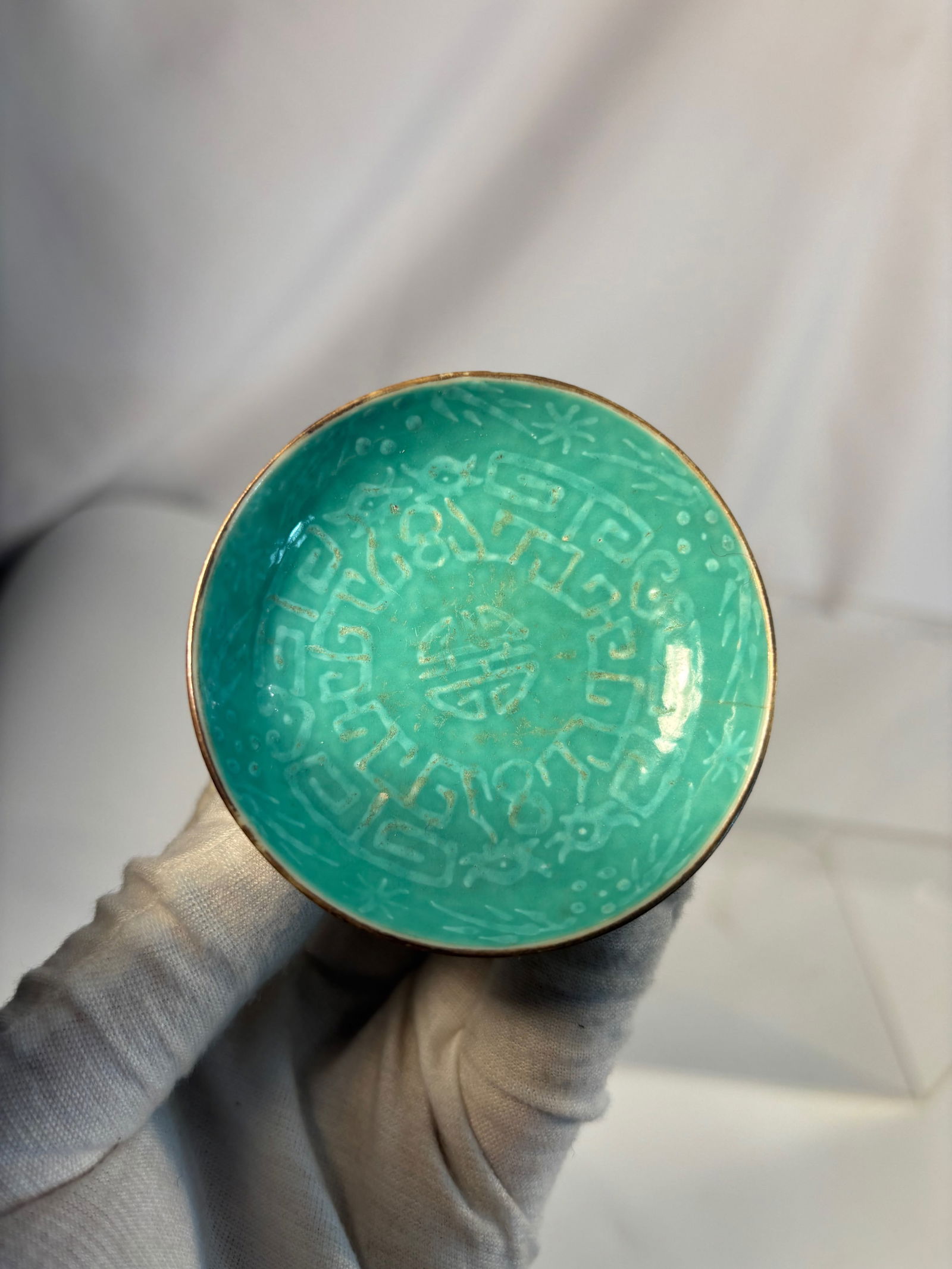 A Chinese Turquoise-Glazed Porcelain Box with Incised Longevity Design, marked "DAO GUANG" Four: Qing dyansty(1644-1912); A finely crafted Chinese turquoise-glazed porcelain box, the domed cover incised with a central shou (longevity) medallion surrounded by a key-fret border. The glaze of rich b
