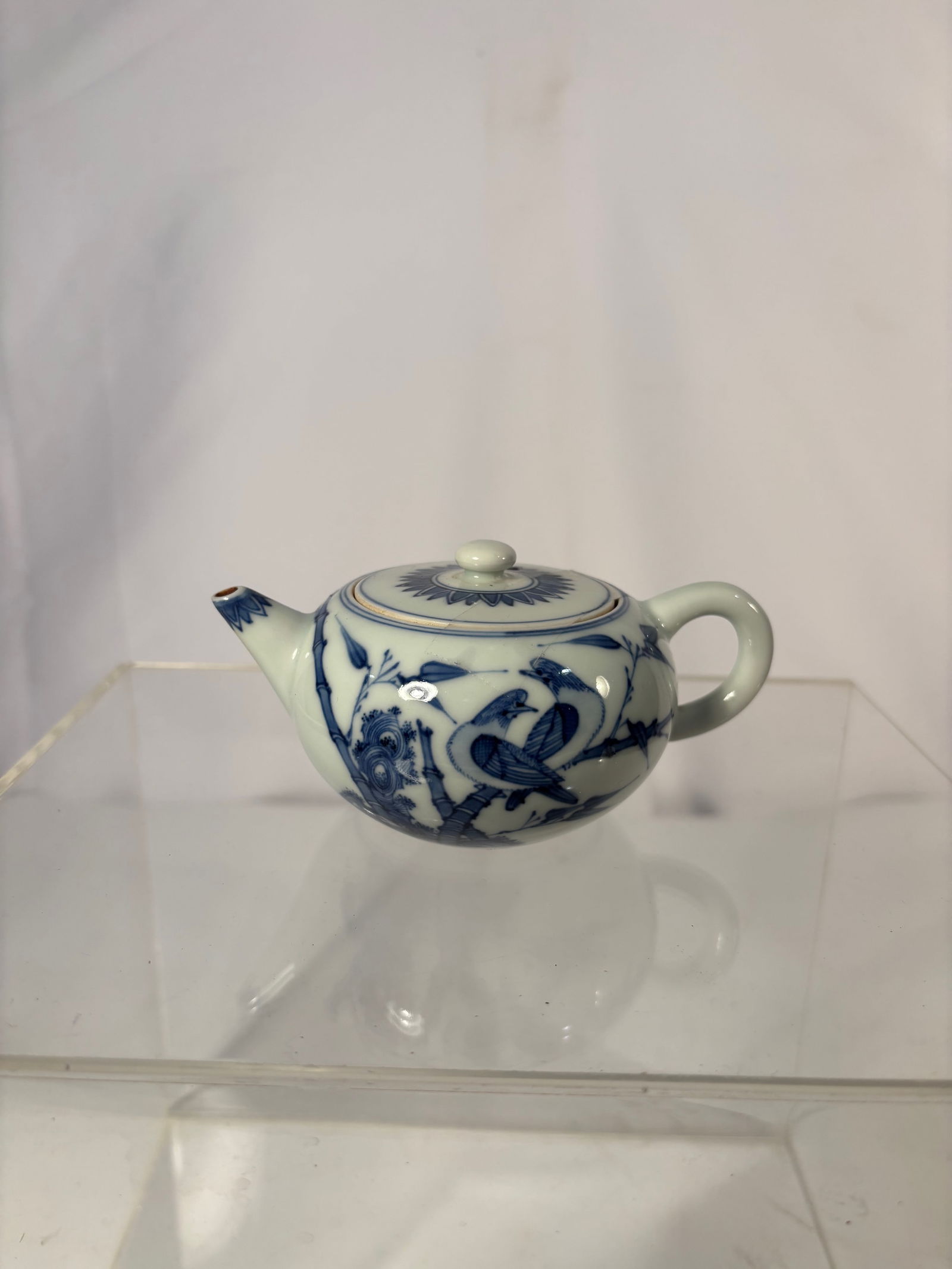 Japanese Blue and White Porcelain Teapot, “Rinshun?? (??) Mark, Arita Ware, Late Edo–Early: (c.1850–1880). A finely hand-painted Japanese blue and white porcelain teapot of rounded form with short spout and loop handle, surmounted by a domed lid with finial. Decorated in vivid underglaze c