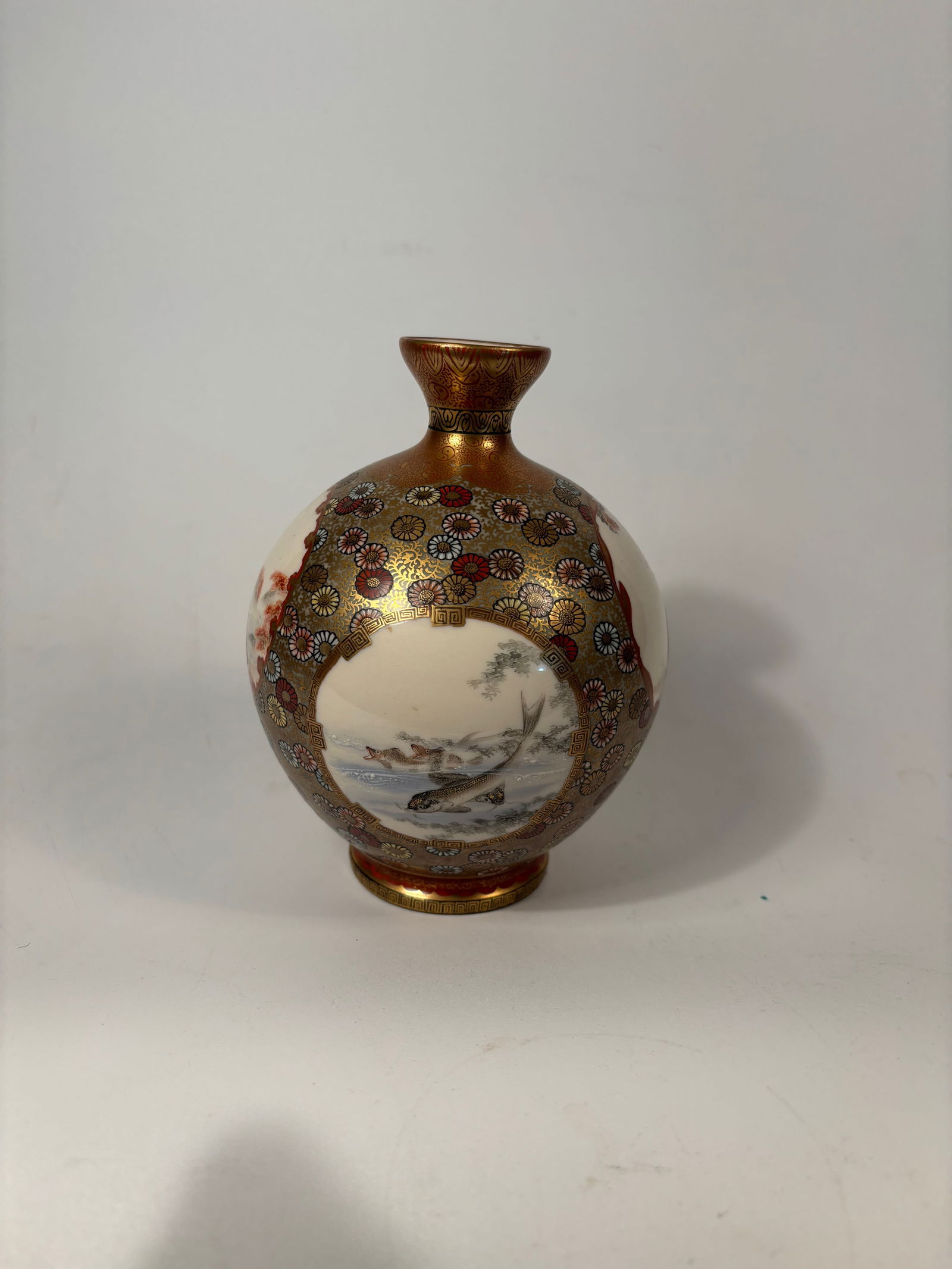 A Japanese Bunraku-style Satsuma porcelain vase with mark: late Meiji (c. 1890–1912) to early Taish? period (c. 1912–1926).The vase shows finely detailed hand-painted panels with traditional Japanese figures, nature scenes, and symbolic motifs like koi, b