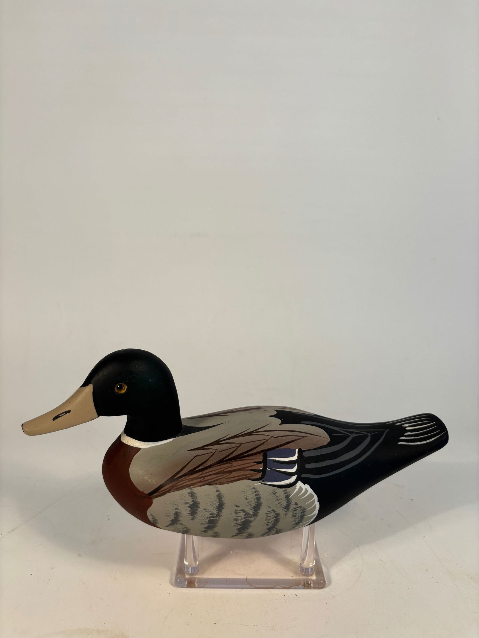 Decorative Mallard Drake Decoy with Stylized Feather Paint: Hand-carved and painted mallard drake decoy featuring highly stylized, symmetrical feather design in bold, contrasting colors. Detailed wing and tail feather motifs on the back, clean and unmarked