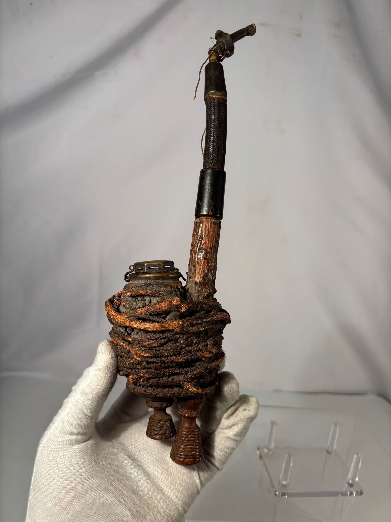 An Early Hand-Carved European Folk Smoking Pipe, 19th century: Early Hand-Carved European Folk Smoking Pipe, the bowl is wrapped with natural wood root fiber used as heat insulation, surrounding a lidded metal chamber with venting. The pipe features a long carved