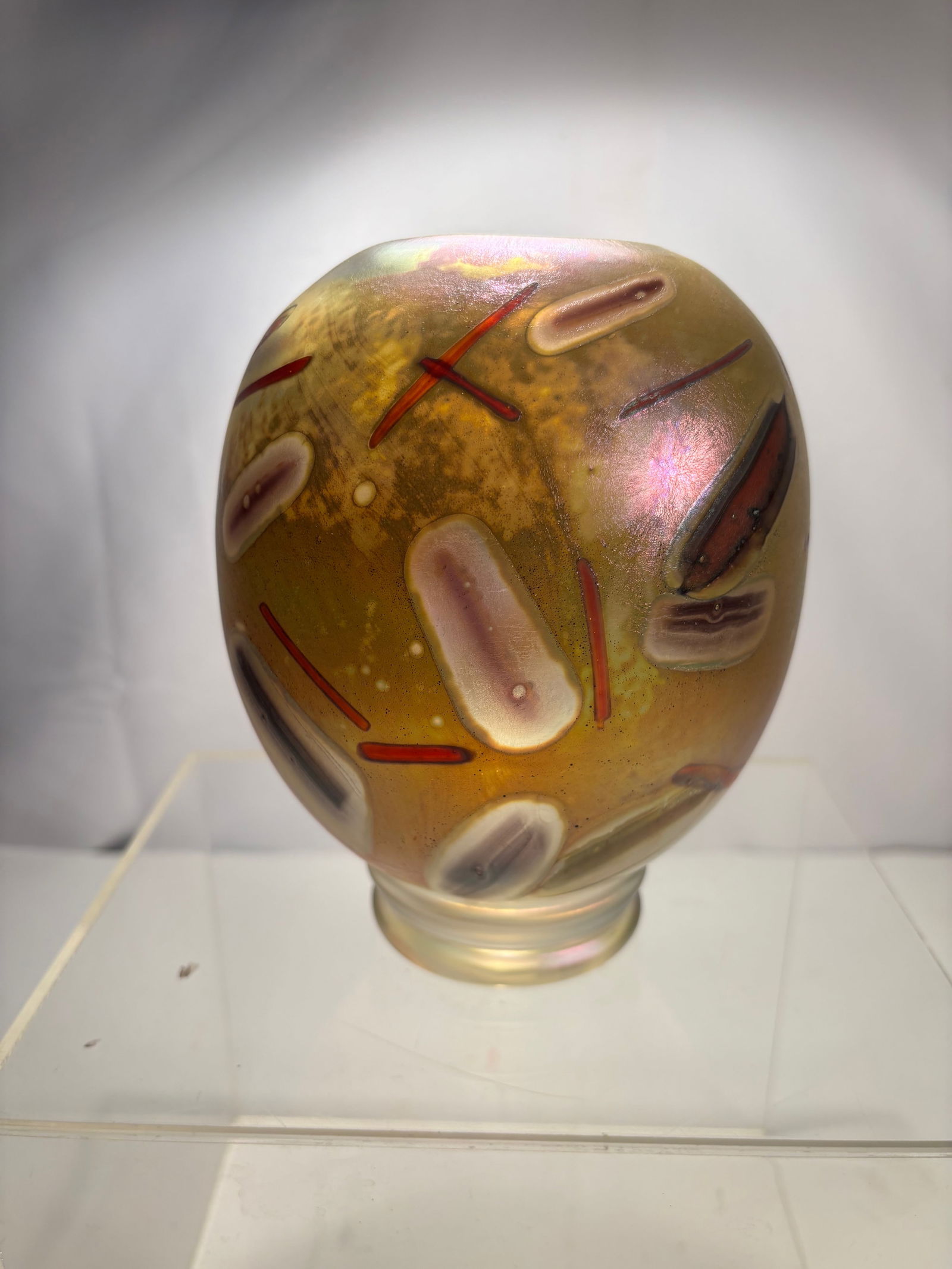 A Bruce Freund Signed Iridescent Studio Art Glass Vase, Dated 1986: Hand-blown studio art glass vessel by Bruce Freund , signed and dated 1986 on the base. The piece is formed in a compact, rounded sculptural shape with a short circular foot and wide opening. Executed