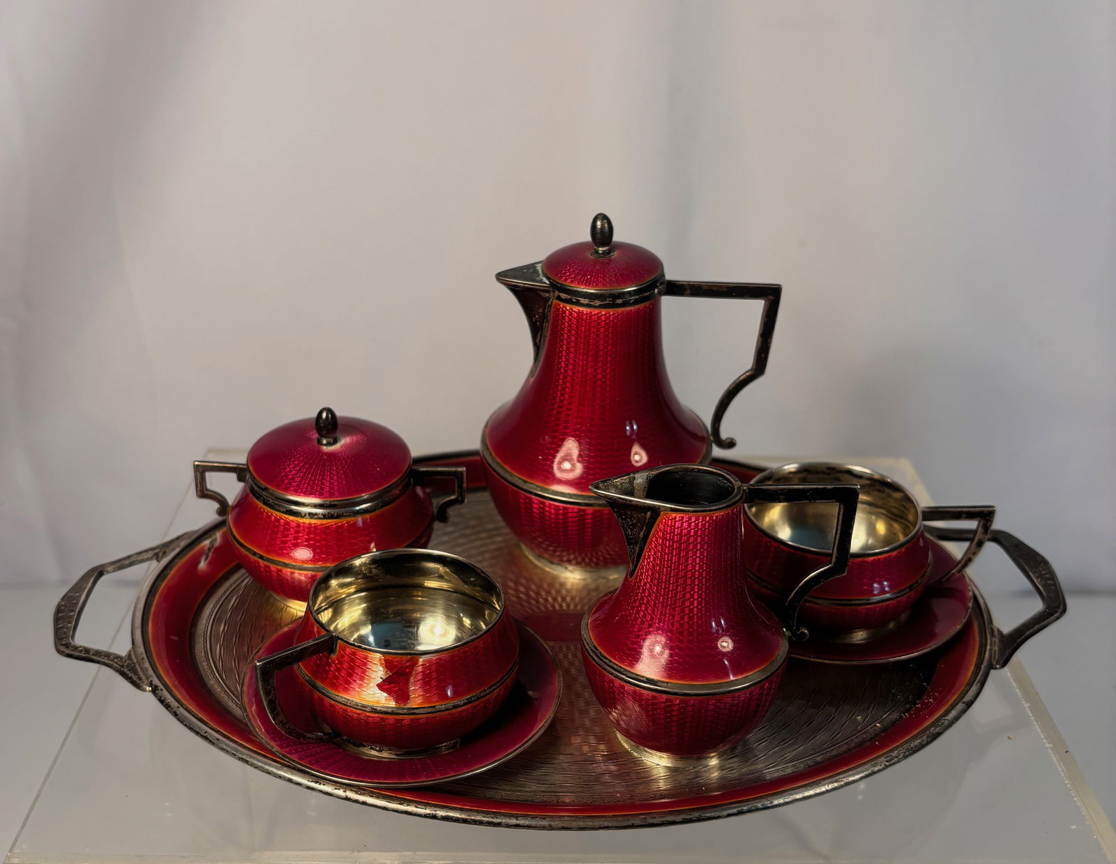 German .935 Silver and Guilloché Enamel Tea and Coffee Service set on Tray, Marked “Sterling: This refined silver enamel service exemplifies German Art Deco silversmithing of the 1920s–1930s, when workshops in Hanau and Pforzheim produced luxurious enamel wares for export to England and the