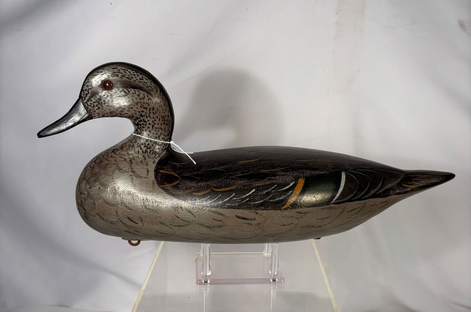 Illinois River Style Weight Pintail Hen Duck Decoy, Signed “Henri Perdew: Carved and painted wooden duck decoy in the Illinois River style, depicting a pintail Hen. The decoy features detailed carved feather patterns, glass eyes, and a weighted underside plate. The base bea