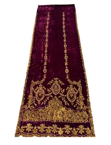 Large Ecclesiastical Velvet Hanging with Gilt Embroidery, 19th/20th Century: Rich burgundy velvet with elaborate gold velvet appliqué and embroidery of scrolling acanthus and floral motifs, the design with suspended oval medallions and a scalloped border, lined on the reverse