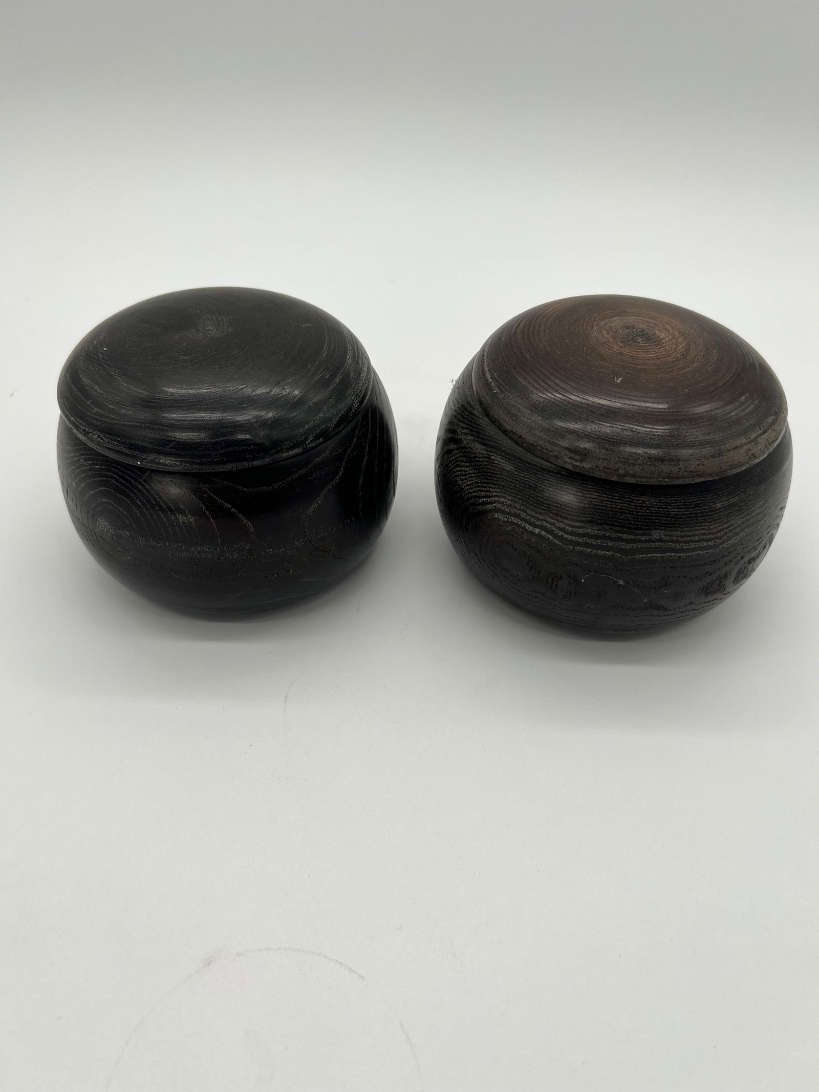 A pair of Japanese wood Wenqi containers: The pair of vintage Weiqi round containers are used to store the game’s stones, (one for black stones and one for white stones), which are all included in the container together. Dimensions?Height: