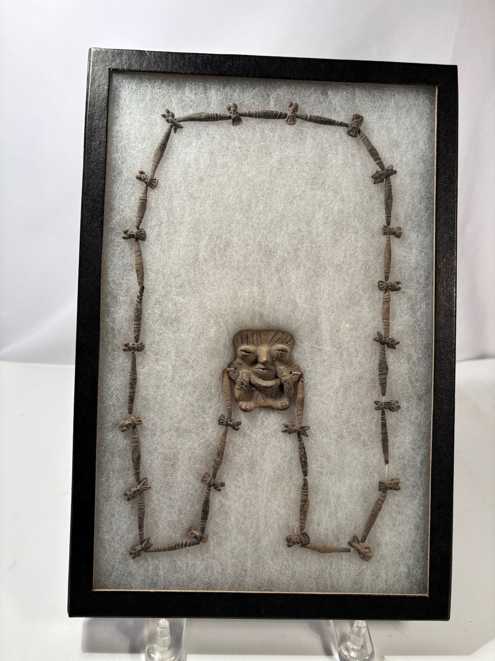 A Pre-Columbian Central American Anthropomorphic Necklace with Figural Pendant: A Pre-Columbian anthropomorphic necklace, likely Central American (Costa Rica–Panama region), composed of hand-formed elongated beads centered by a stylized human figure pendant. The figure displays