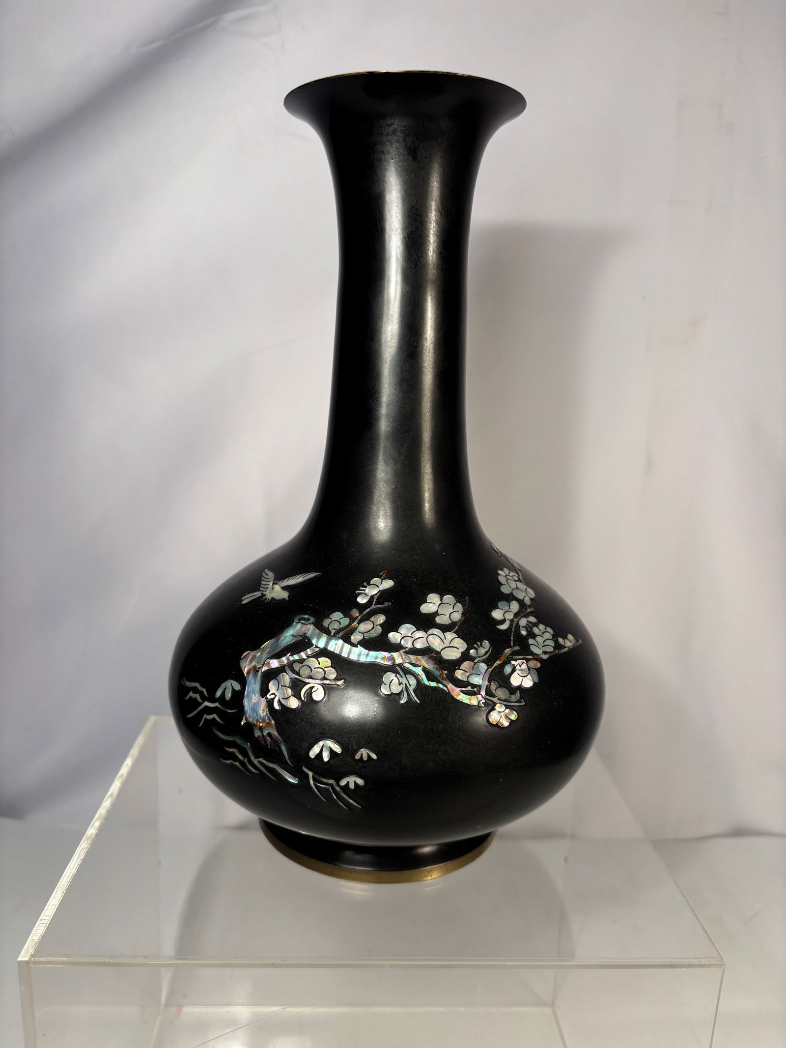 A Korean Bronze Vase with Inlaid Bird and Floral Decoration: A Korean bronze vase of baluster form with a flared neck, decorated in silver-toned metal inlay depicting birds perched among blossoming branches. The dark patinated ground provides strong contrast to
