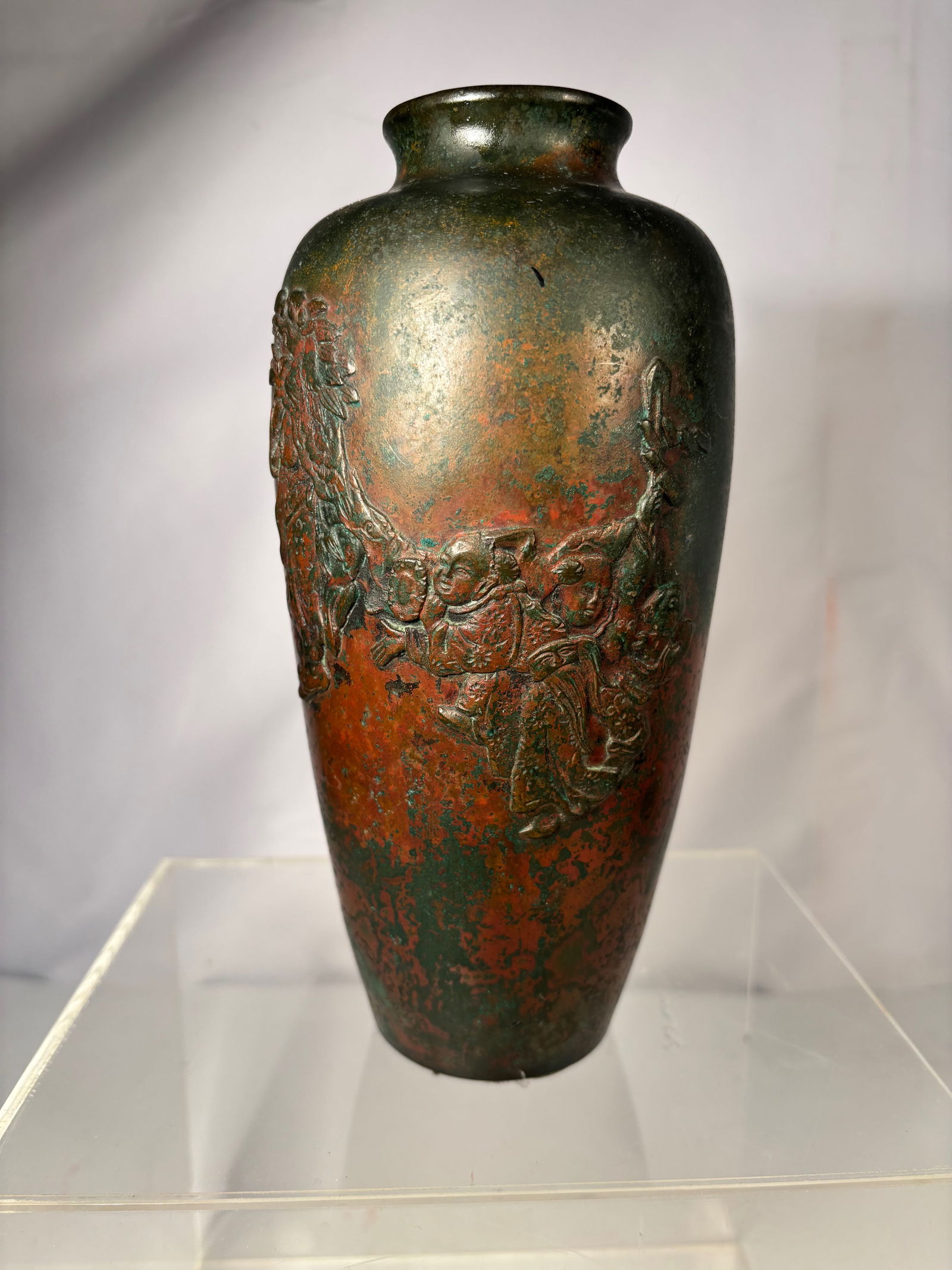 A Japanese Bronze Vase with High Relief Figural Decoration and Mottled Patina: Probably 18-19th century, Japanese bronze vase of baluster form featuring high relief figural decoration. The body depicts children and auspicious motifs rendered in raised detail, set against a richl