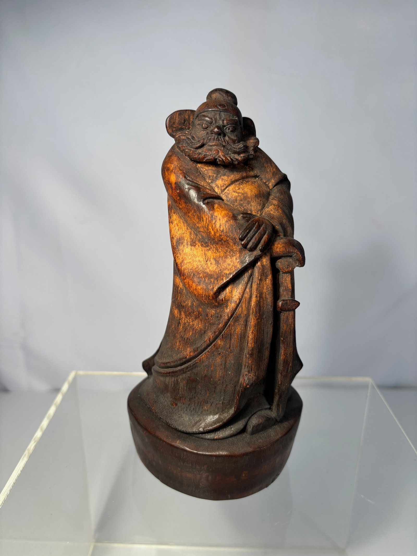 A Chinese Bamboo Root Carving of Guan Yu: Qing Dynasty(1644-1912),A Chinese bamboo root carving figure, depicting a standing bearded warrior, likely Guan Yu, wearing long robes and holding a sword. The figure carved making use of the natural