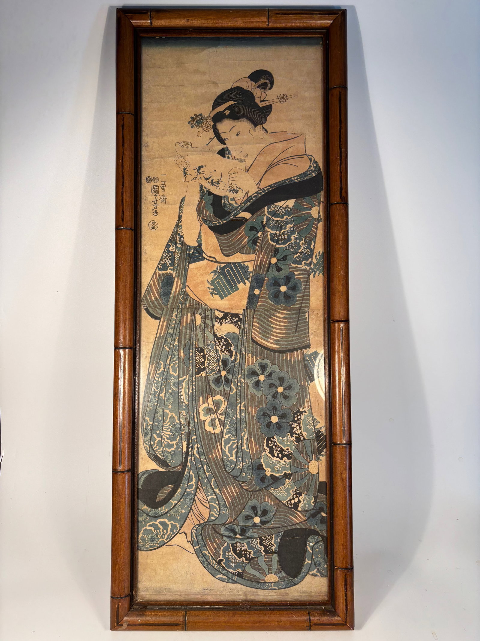 Utagawa Kuniyoshi Woodblock Print – Edo Period Bijin Portrait, Signed: Mid-19th century, likely 1840s–1850s; The figure is a bijin (beautiful woman), holding an item (possibly a poem slip or towel), dressed in intricate kimono. This is likely part of Kuniyoshi’s biji