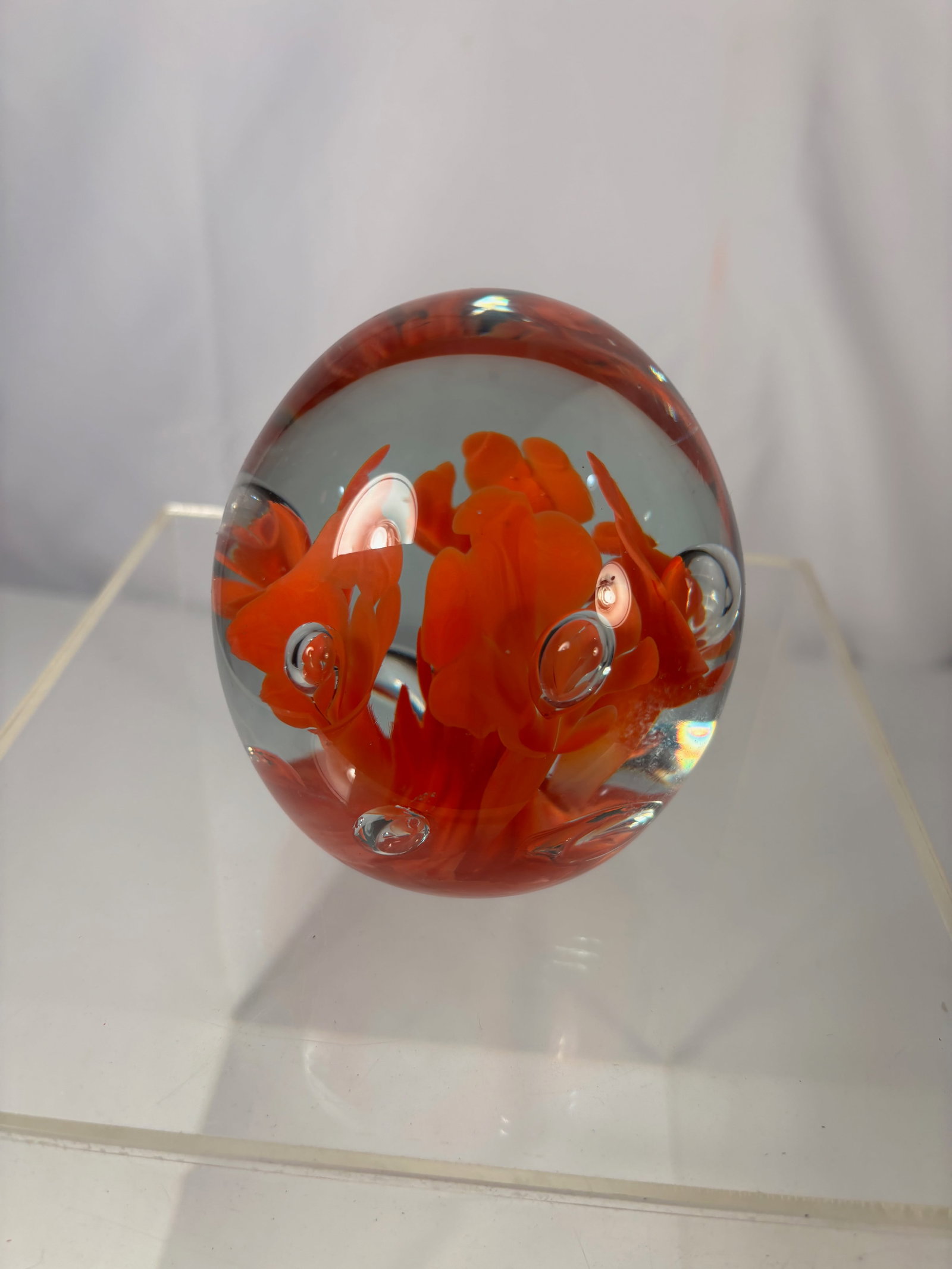St. Clair / Joe St. Clair Art Glass Paperweight with Red Floral Inclusions & Controlled Bubbles: Decorative art glass paperweight featuring a clear domed form with vivid red floral-style inclusions rising from the base, accented by controlled air bubbles that add depth and dimension. The bold col