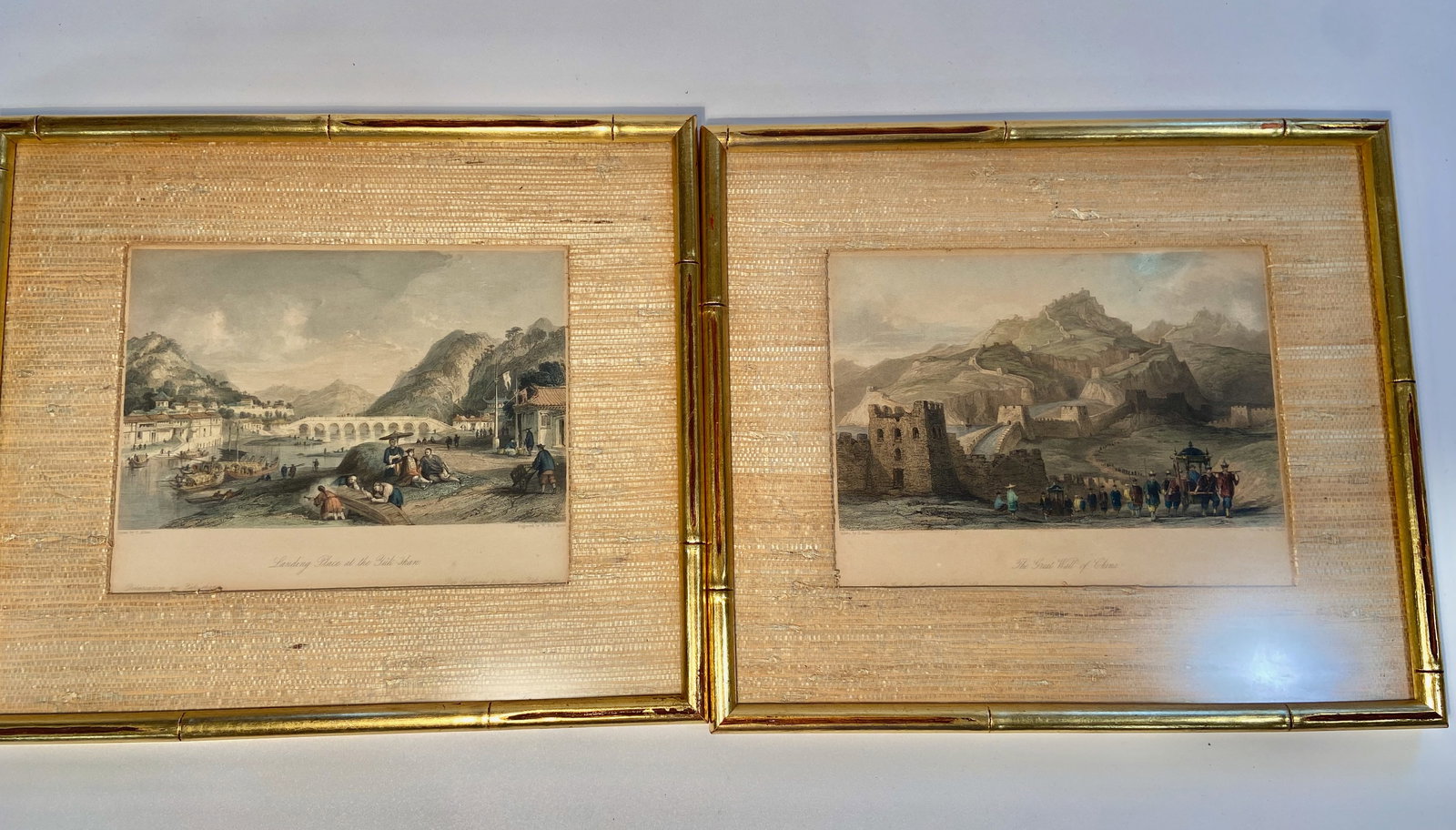 A set of two engraved printa " view of China ": 19th Century; One is titled “Landing Place at the Pik-shan”, with detailed illustrations of a riverside scene featuring people and boats, likely depicting a historical or cultural view of Chin