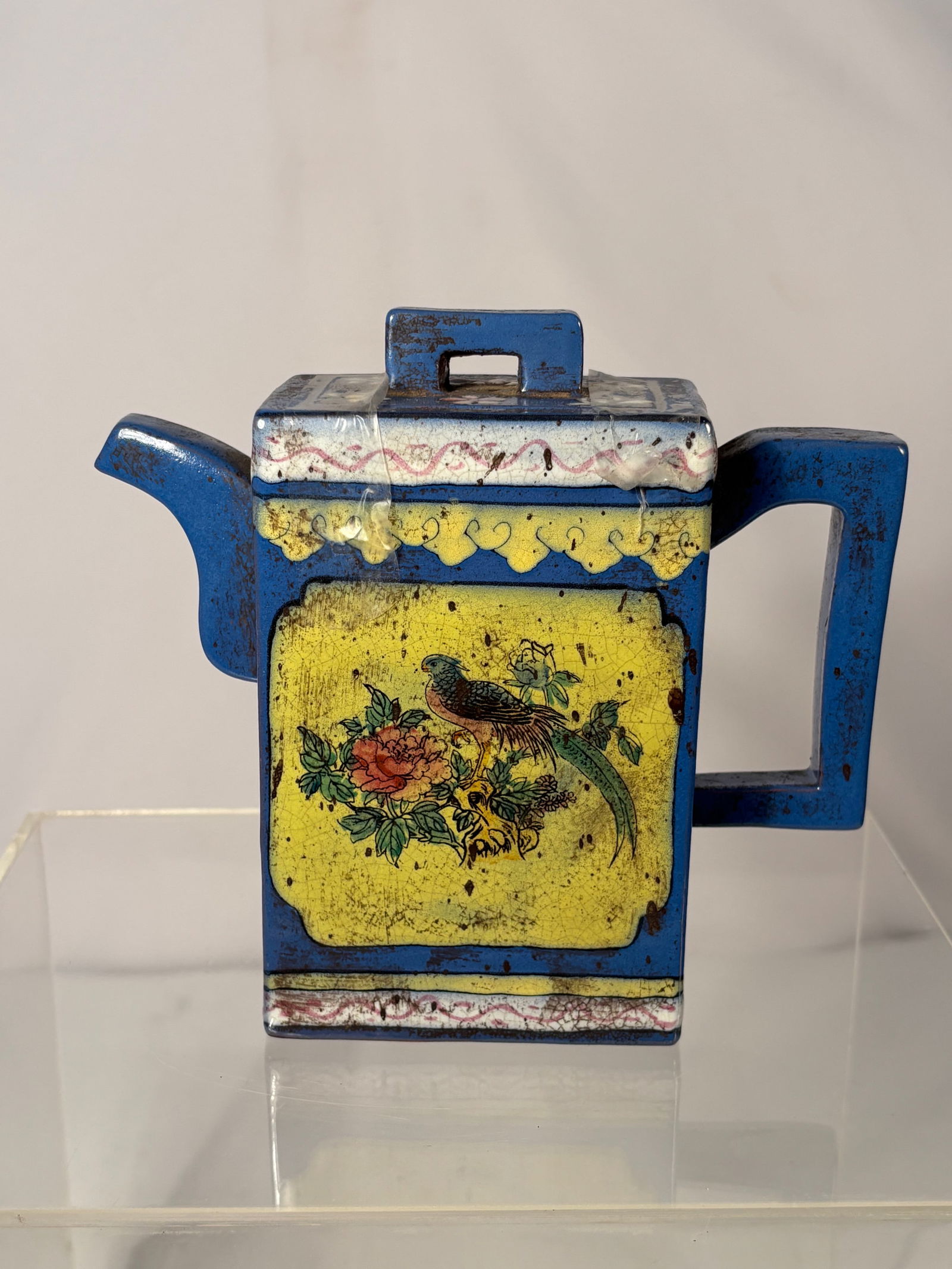 A Chinese Yixing Zisha Teapot with Enamel Decoration with mark: A Chinese Yixing zisha teapot decorated with colorful enamel-painted floral and bird motifs applied over a traditional zisha clay body. The teapot features a square-form body, angular handle, and matc