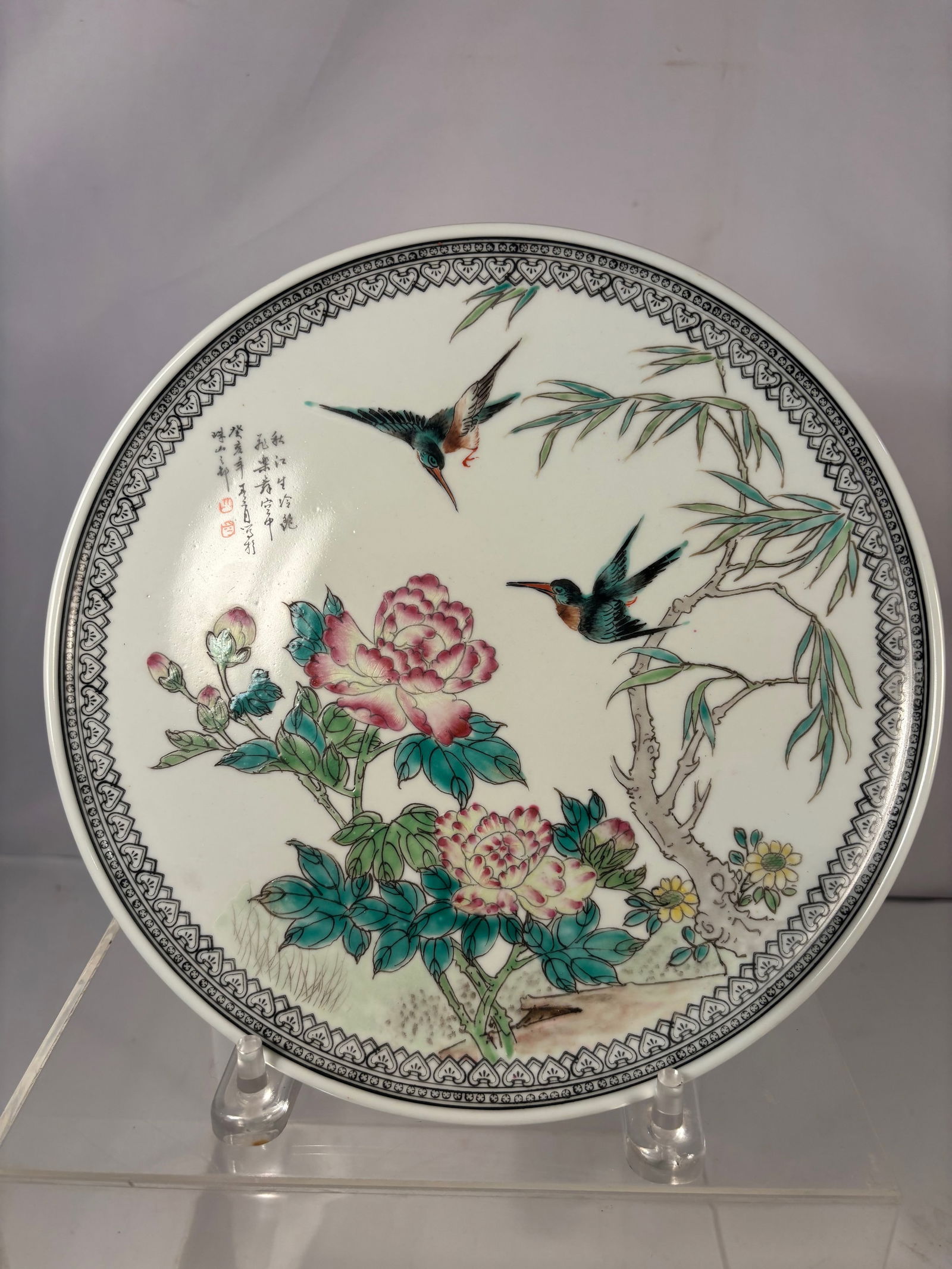 A Chinese Porcelain Plate with Kingfishers and Peonies: Republic period (1912–1949), produced at Jingdezhen and finely decorated in polychrome enamels. The central scene depicts kingfisher birds in flight and at rest among peony blossoms, bamboo leaves,
