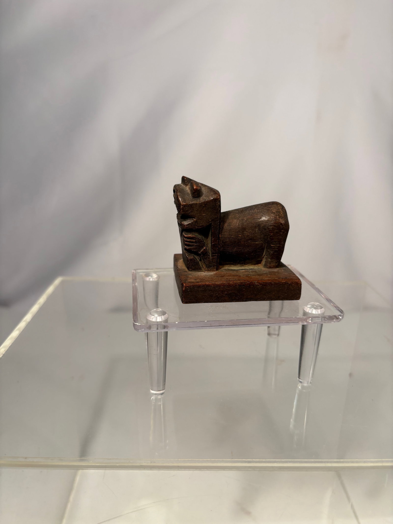 A Japanese Carved Wood Seal Stamp with Characters: Japanese carved wood stamp of square form, incised with stylized characters and geometric framing. Executed in relief for use as a hand stamp, with a darkened surface patina from age and handling. Hei