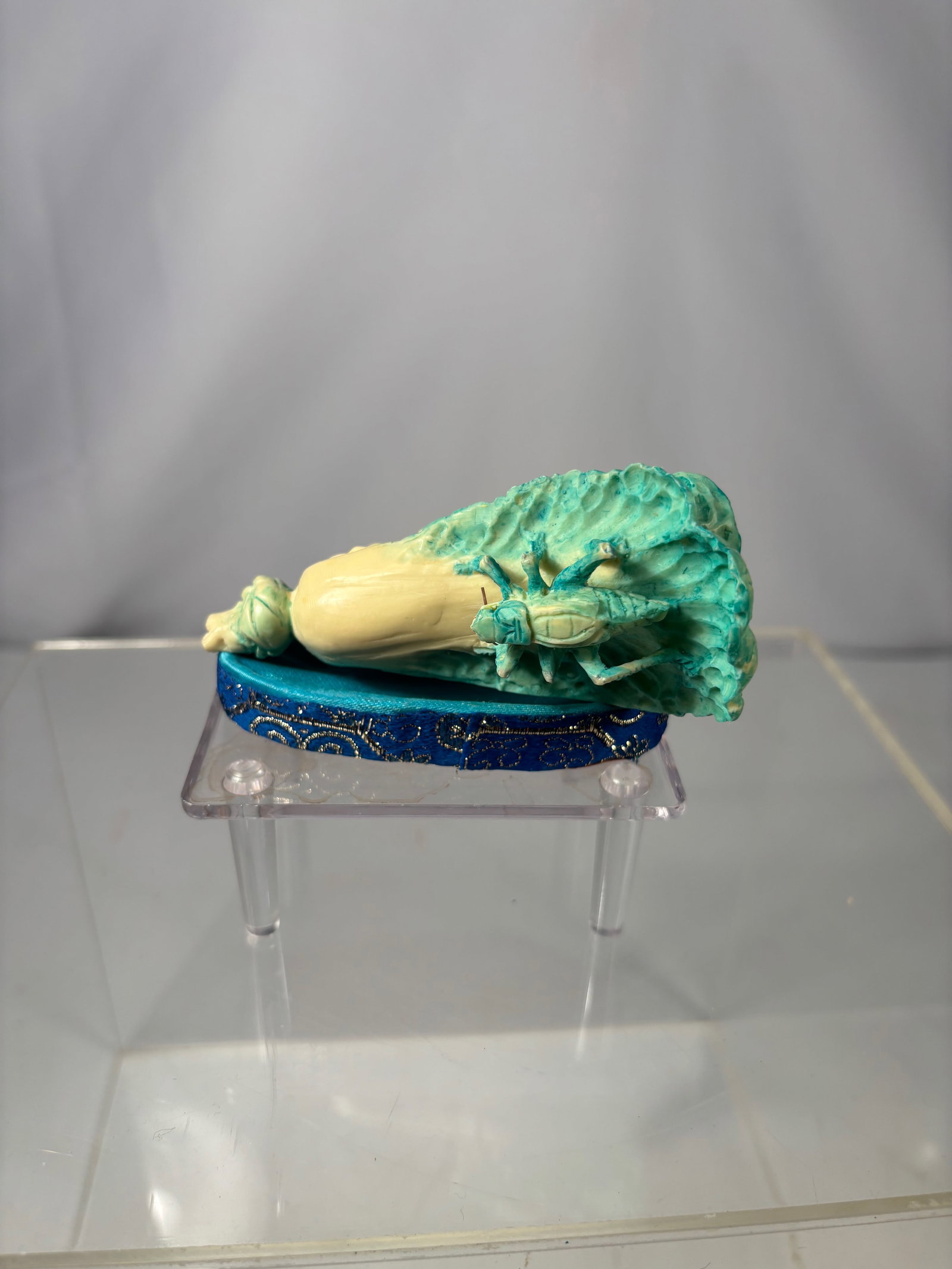 A Chinese Carved Bone Cabbage with Insects: Early 20th century; Chinese carved bone figure modeled as a cabbage with leafy ribs and naturalistic detailing, accompanied by carved insects. The carving makes use of the natural coloration of the bo