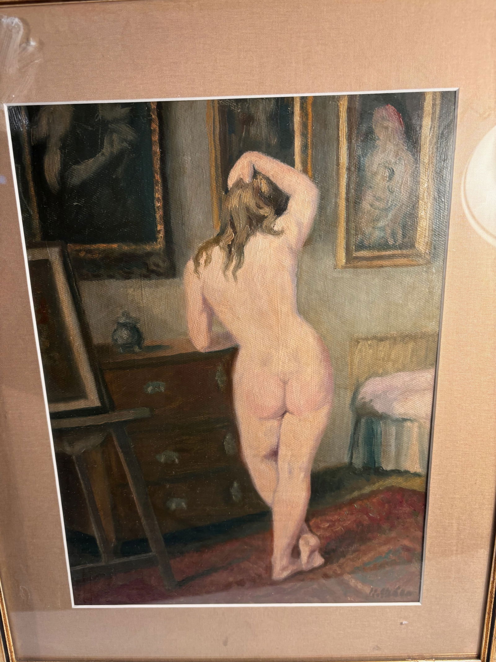 Karel Skála (Czech-American, 1908–2001), “Nude Standing II,?? Oil on Board: Oil on board depicting a standing nude female figure viewed from behind in a softly lit artist’s studio interior. Warm ochre and rose tones emphasize the model’s form against a backdrop of framed