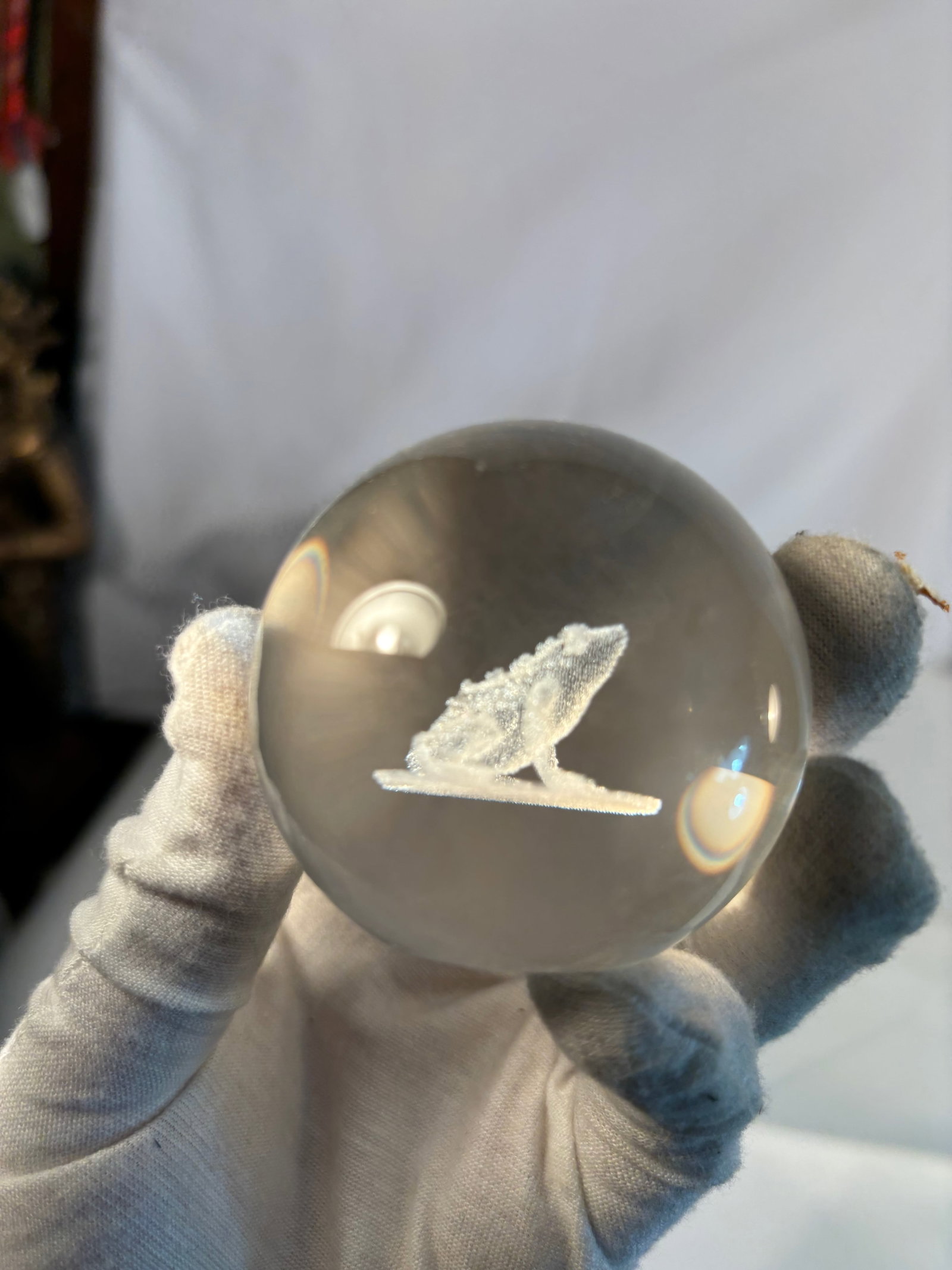 Crystal Glass Paperweight with 3D Laser-Etched Frog: A clear crystal glass paperweight featuring a detailed three-dimensional laser-etched frog resting on a lily pad, suspended within the solid glass sphere. The frog is intricately rendered with lifelik