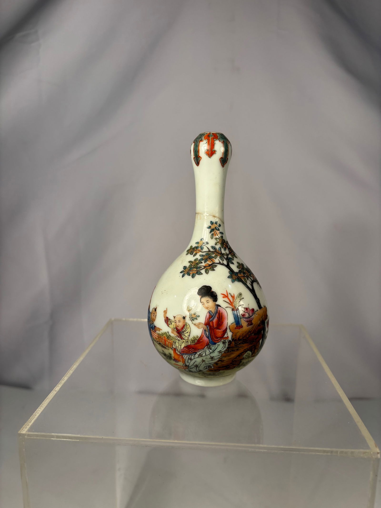 A Chinese Famille Rose Enamel Garlic-Mouth Porcelain Vase with "QianLong Mark": Qing dynasty(1644-1912);Executed in soft pastel enamels with gilt details, the painting displays the meticulous brushwork and elegant palette,The neck is encircled with stylized ribbon and scroll moti