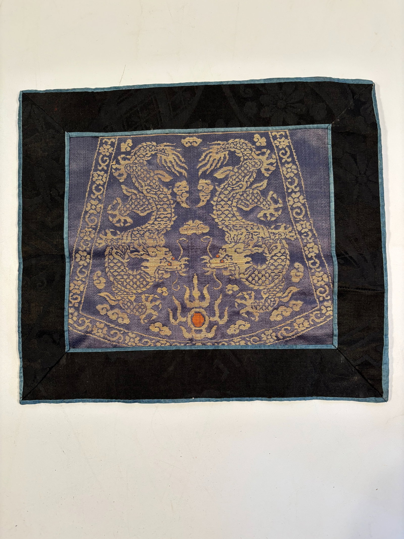 A Chinese woven silk dragon panel: Qing Dynasty (1644-1912) ;Two dragons: Both facing a flaming pearl, a motif associated with cosmic energy, wisdom, and the Emperor. Dimensions?Length:11 inches ; Width: 9 inches.