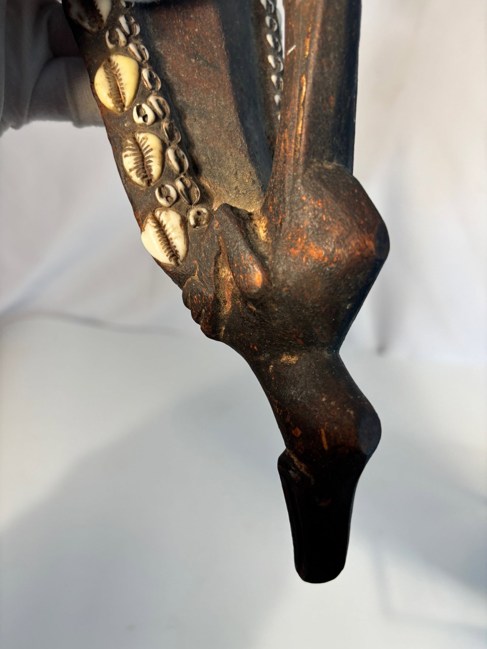 Papua New Guinea Cowrie-Shell Adorned Wooden Mask, Sepik River Region: Early to Mid 20th century ; A finely carved wooden ceremonial mask from the Sepik River region of Papua New Guinea, richly decorated with rows of natural cowrie shells along the contours of the face.