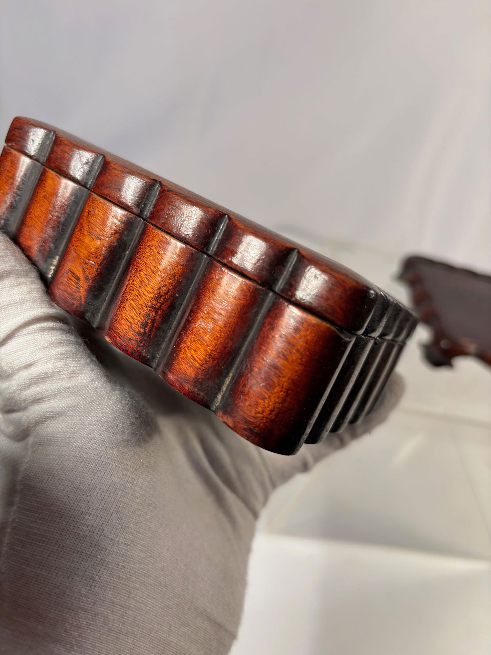 A fine Chinese hardwood/ huanghuali Scholar’s Box on Hardwood Stand: Qing dynasty(1644-1912); Rectangular Chinese hardwood/Huanghuali scholar’s box with a fitted cover, raised on a conforming openwork stand. The box features a smooth patina and well-proportioned form