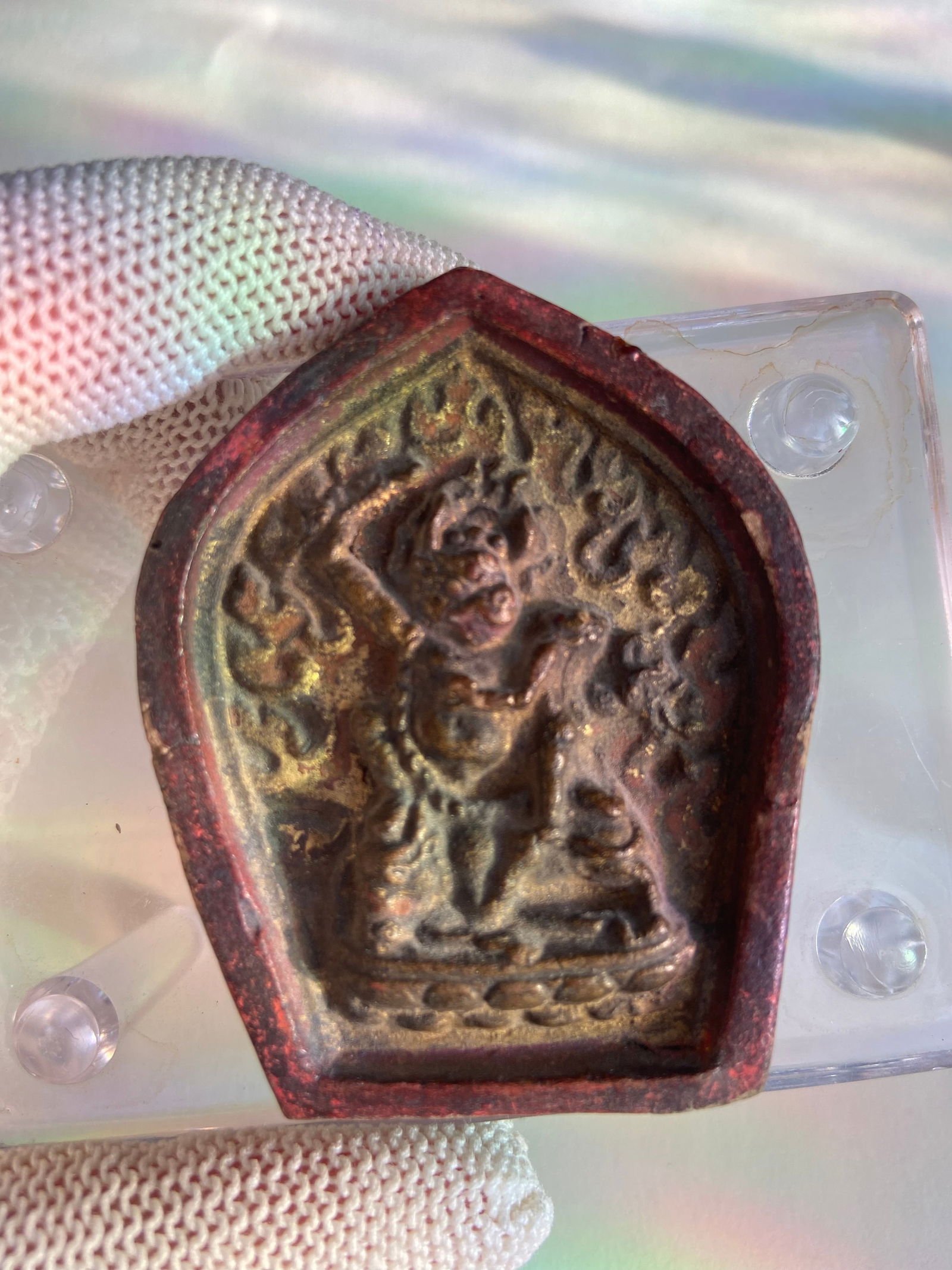 Tibetan terracotta tsa-tsa plaque: 19th century ,A Tibetan tsa-tsa plaque molded in relief, depicting a wrathful deity (likely Vajrapani or Mahakala) encircled by flames, symbolizing spiritual protection and purification. Created from