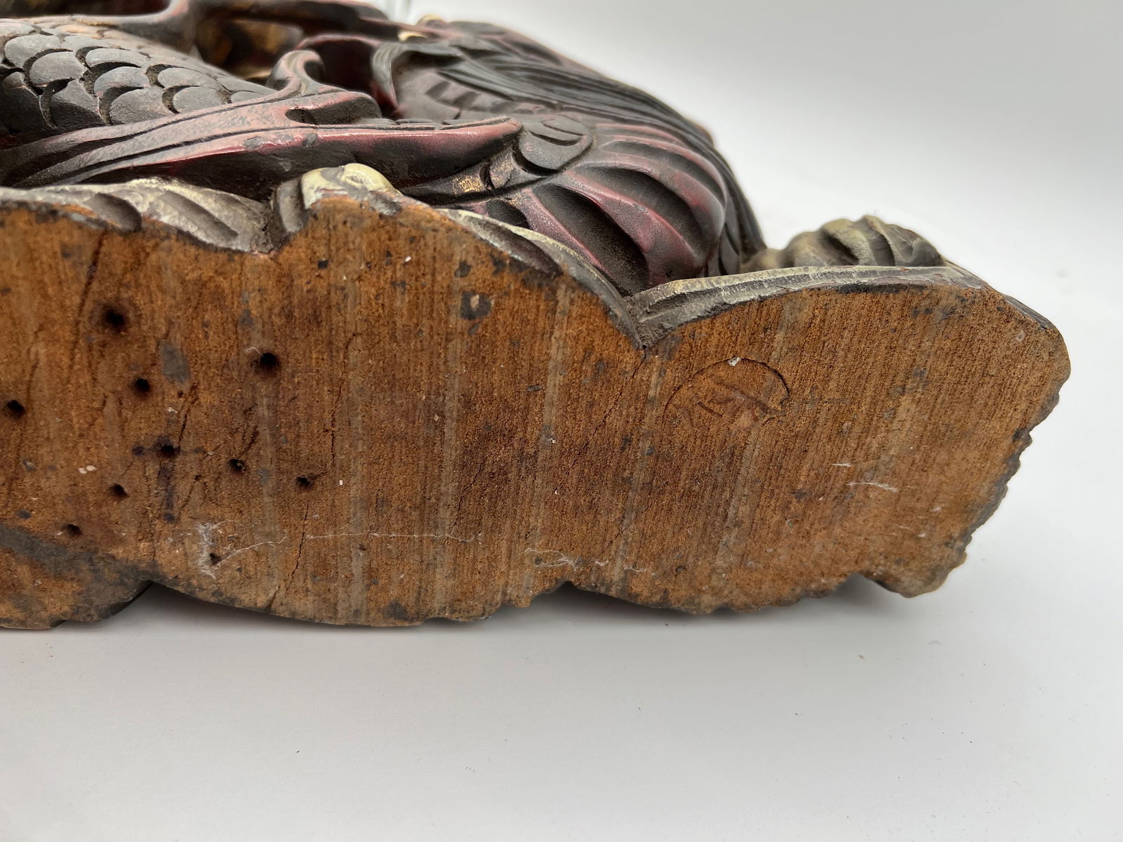 A large Chinese hand carved gilt dragon wood statue: 19th century; The carved wooden sculpture featuring two intertwined dragons. The carving shows two dragons interacting, possibly chasing a “flaming pearl” or “sacred jewel,”.