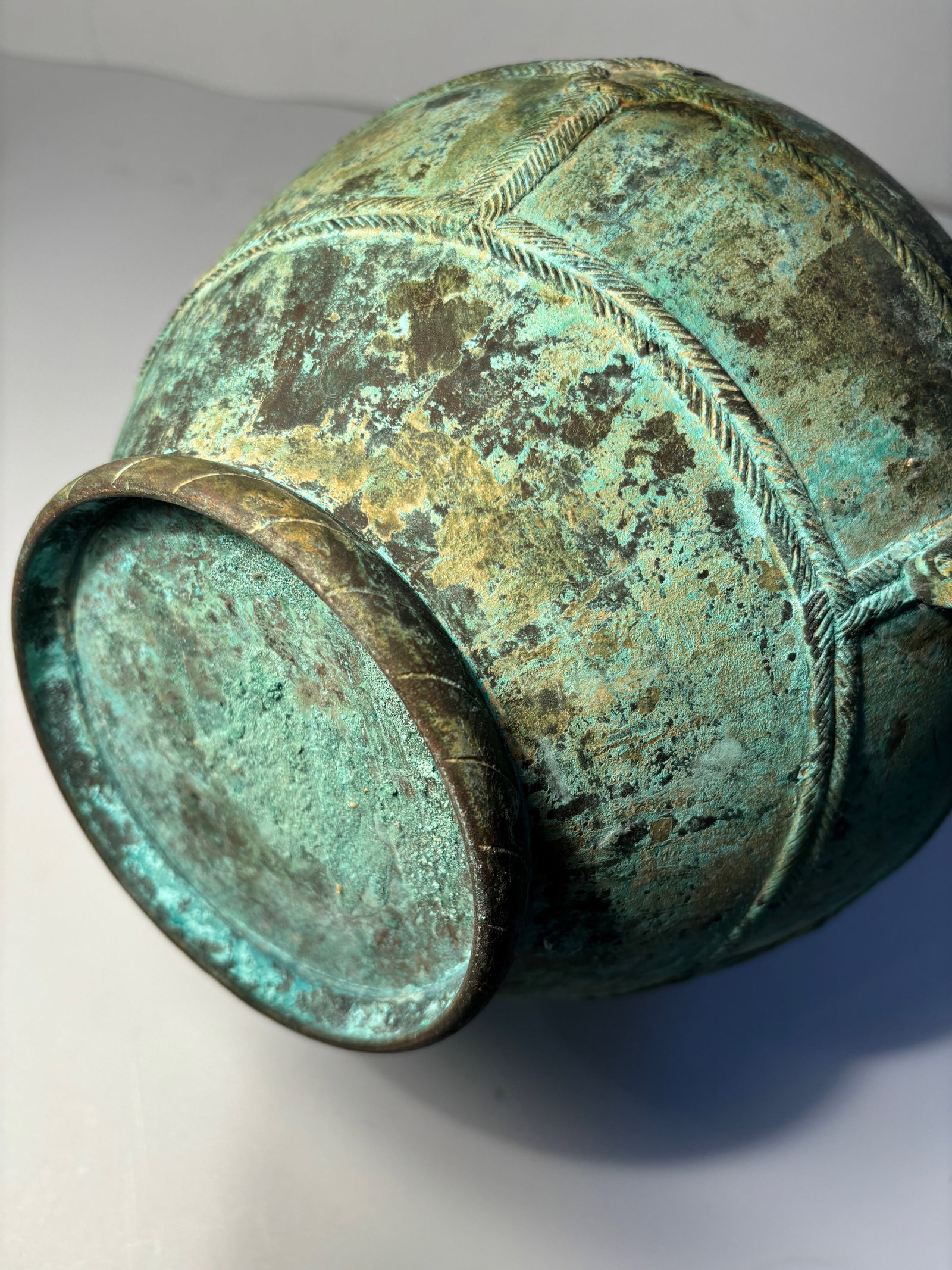An archaic bronze vase, hu, China, probably Han Dynasty: Probably Han Dynastyof globular form, flanked by two small loop handles, the body encircled by two raised fillets, the ground with malachite encrustations.Provenance: From an prominent Midwest family