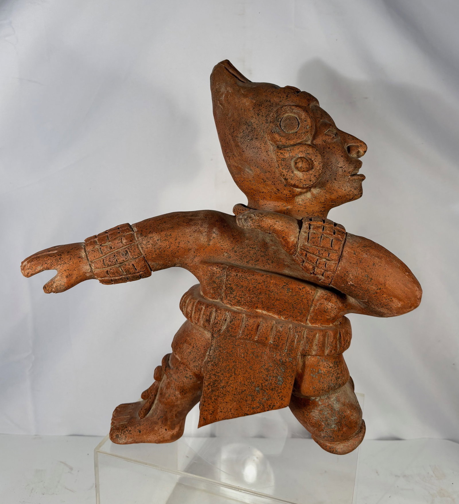 Redware Ceramic Warrior Figure, Mexico, in Pre-Columbian Style: A redware ceramic figure rendered in the distinctive style of West Mexican ancient sculpture, depicting a kneeling warrior with a crested headdress, ear ornaments, and a detailed beaded collar. The fi