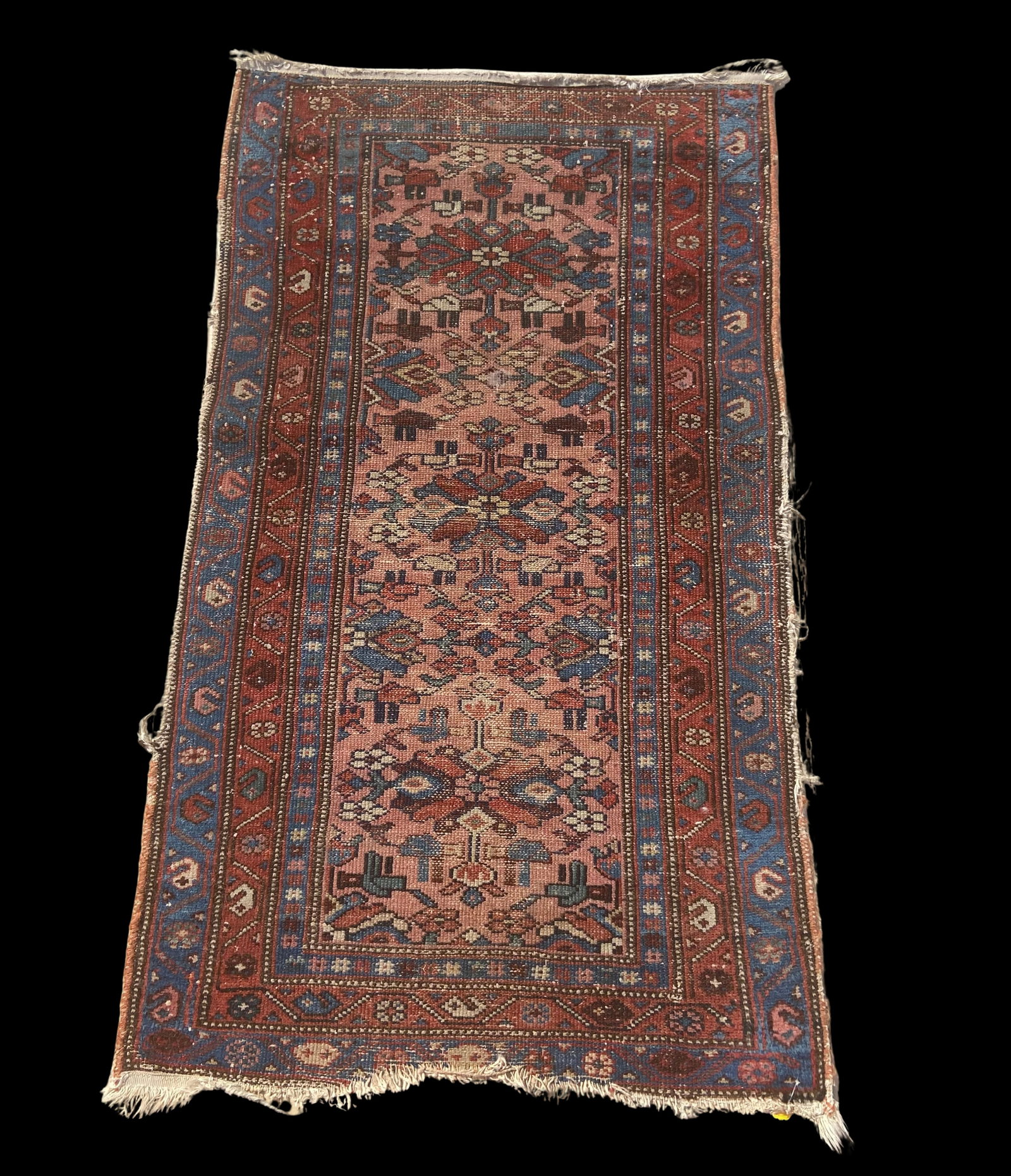 Antique Persian hand-knotted Tribal Rug, Caucasian Karabagh Style: This antique hand-knotted Persian tribal rug, woven in the Northwest Persian / Caucasian tradition, features a warm salmon field decorated with stylized geometric motifs in shades of red, blue, and iv