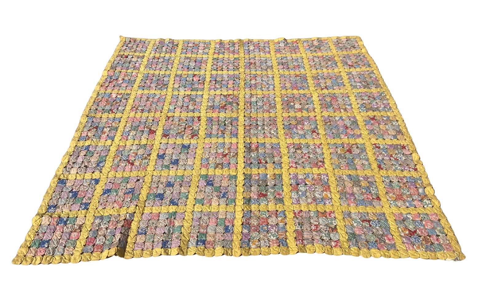 Vintage Handmade Yo-Yo Quilt, Floral Cotton Patchwork w/ Yellow Grid Design: This vintage handmade yo-yo quilt features a charming patchwork design composed of individually gathered fabric “yo-yos” arranged in a structured grid pattern. Each small circular piece is han