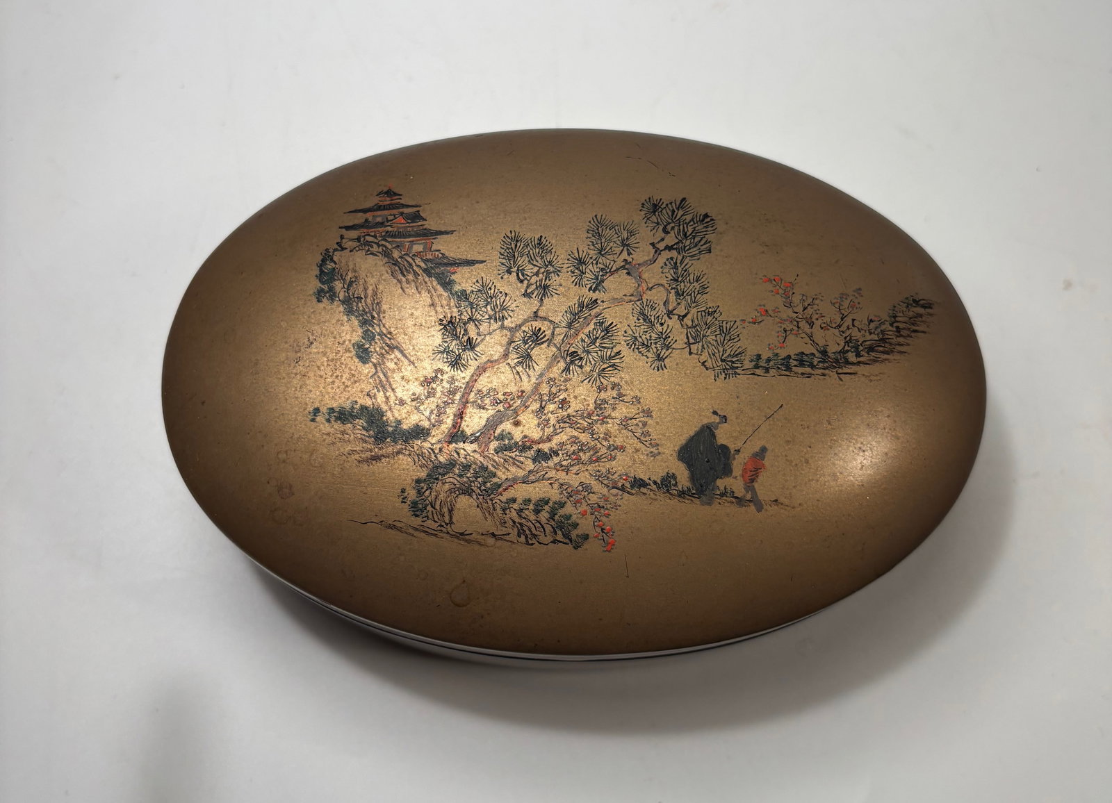 A Chinese Foochow Lacquer Box with Landscape Decoration: Qing Dynasty(1644-1912) ; Chinese lacquer box decorated with a landscape scene in gilt. The base marked “Foochow.” Height: 2 inches; Length: 5.25 inches; Width:3.75 inches.