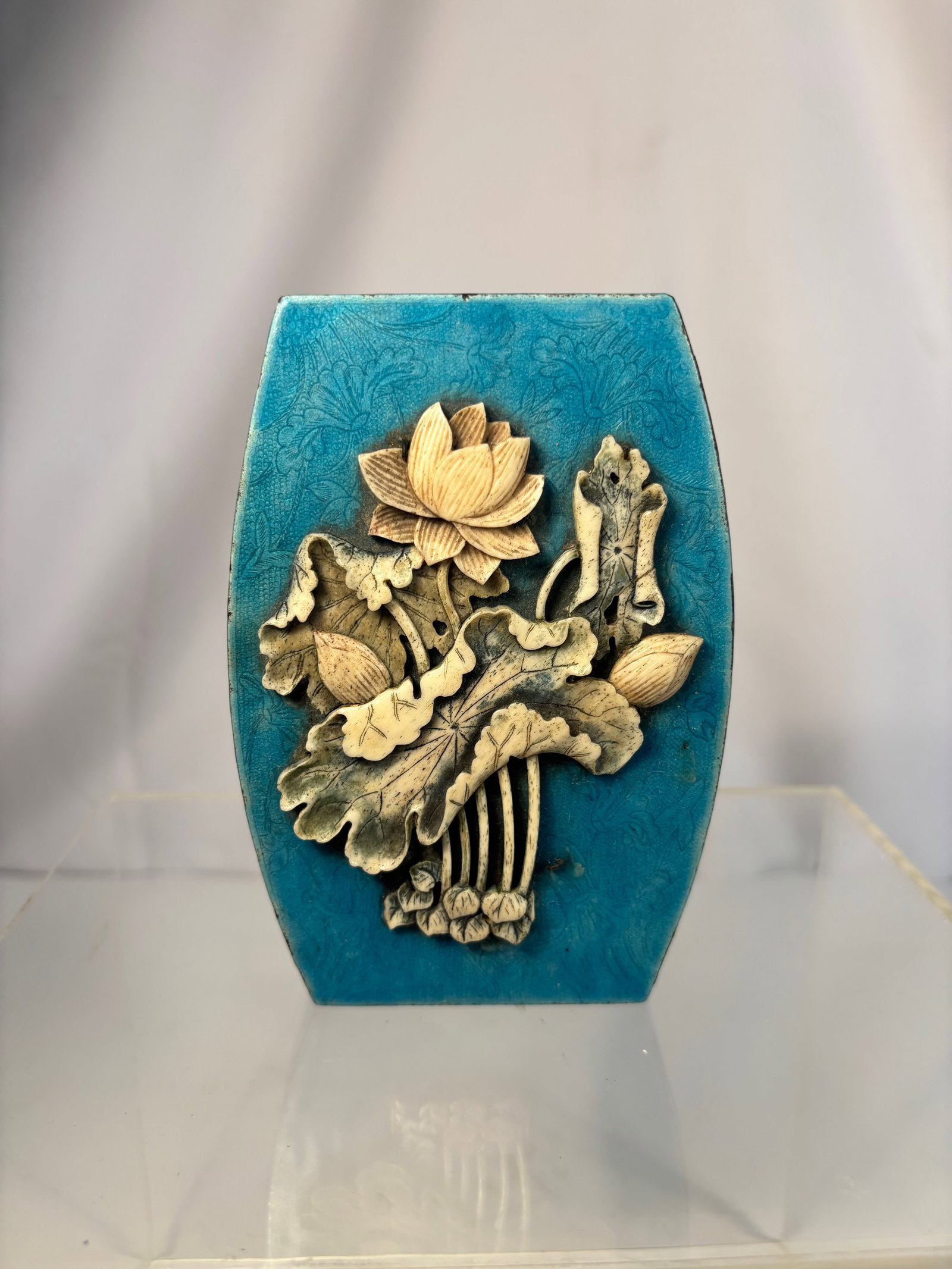 A Chinese Enamel Box with Carved Bone Lotus Design: Qing dyansty(1644-1912); A finely made Chinese enamel and bone inlaid box of waisted rectangular form, the lid decorated with a carved bone relief of lotus flowers and leaves, symbolizing purity and h