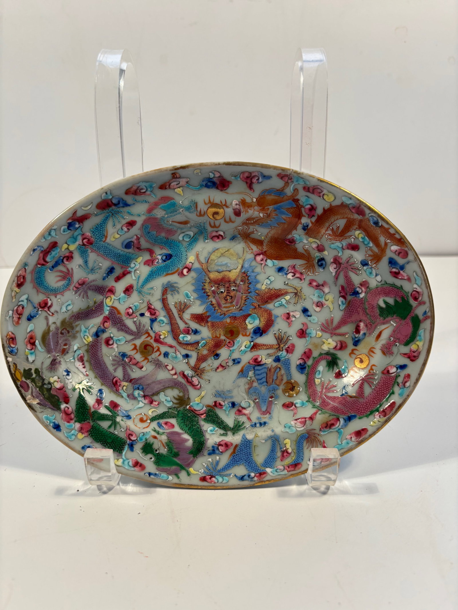 A Chinese famille rose porcelain dragon plate: Qing Dynasty (1644-1912), The design features five-clawed imperial dragons amidst clouds and flames. Dimensions?qq
