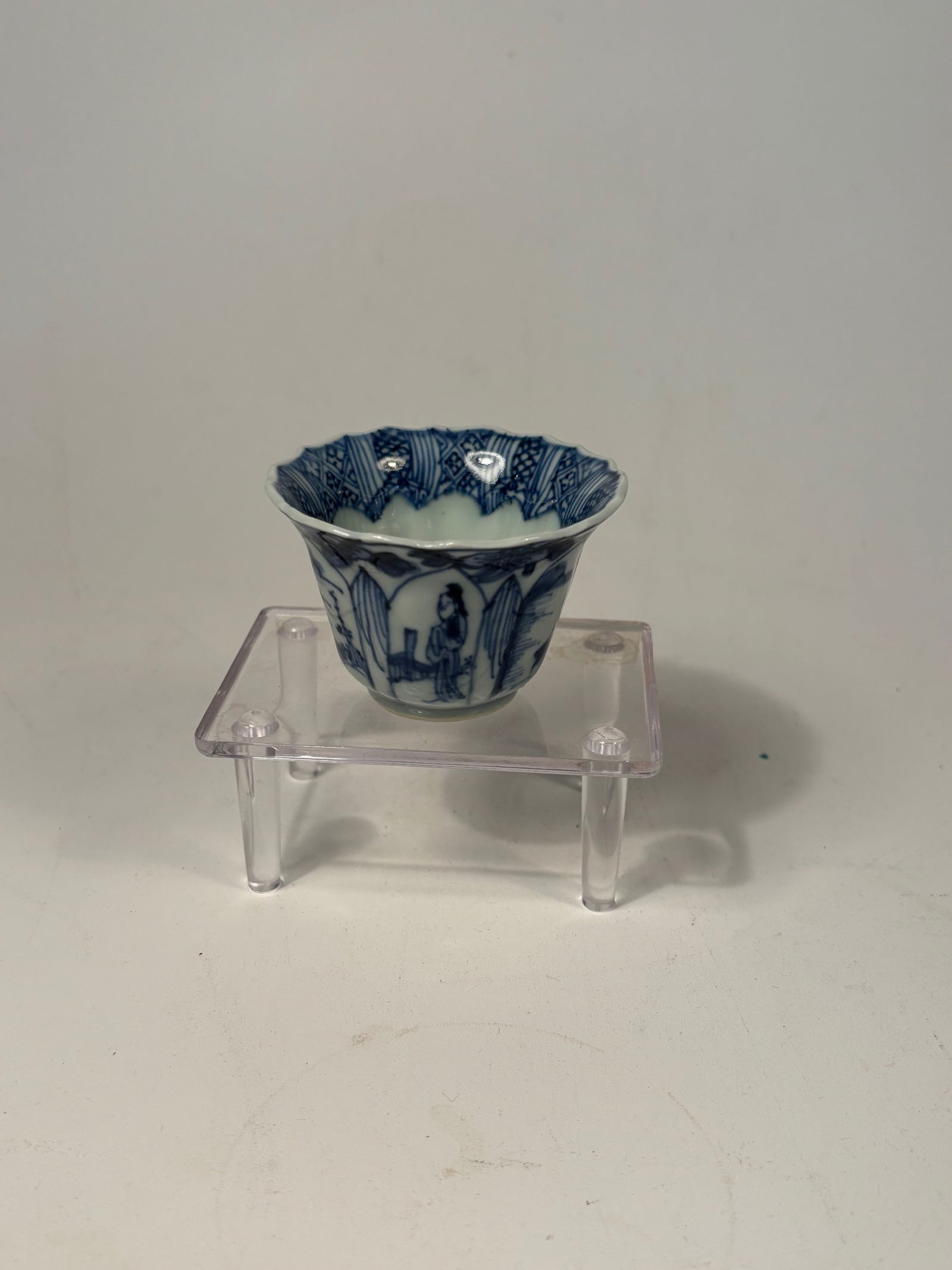 A Chinese Blue and White Porcelain Fluted Cup, Kangxi Period: Kangxi period (1662–1722);A finely potted Chinese blue and white porcelain cup, the body lobed and flared with a barbed rim. The exterior and interior are delicately painted in underglaze cobalt blu