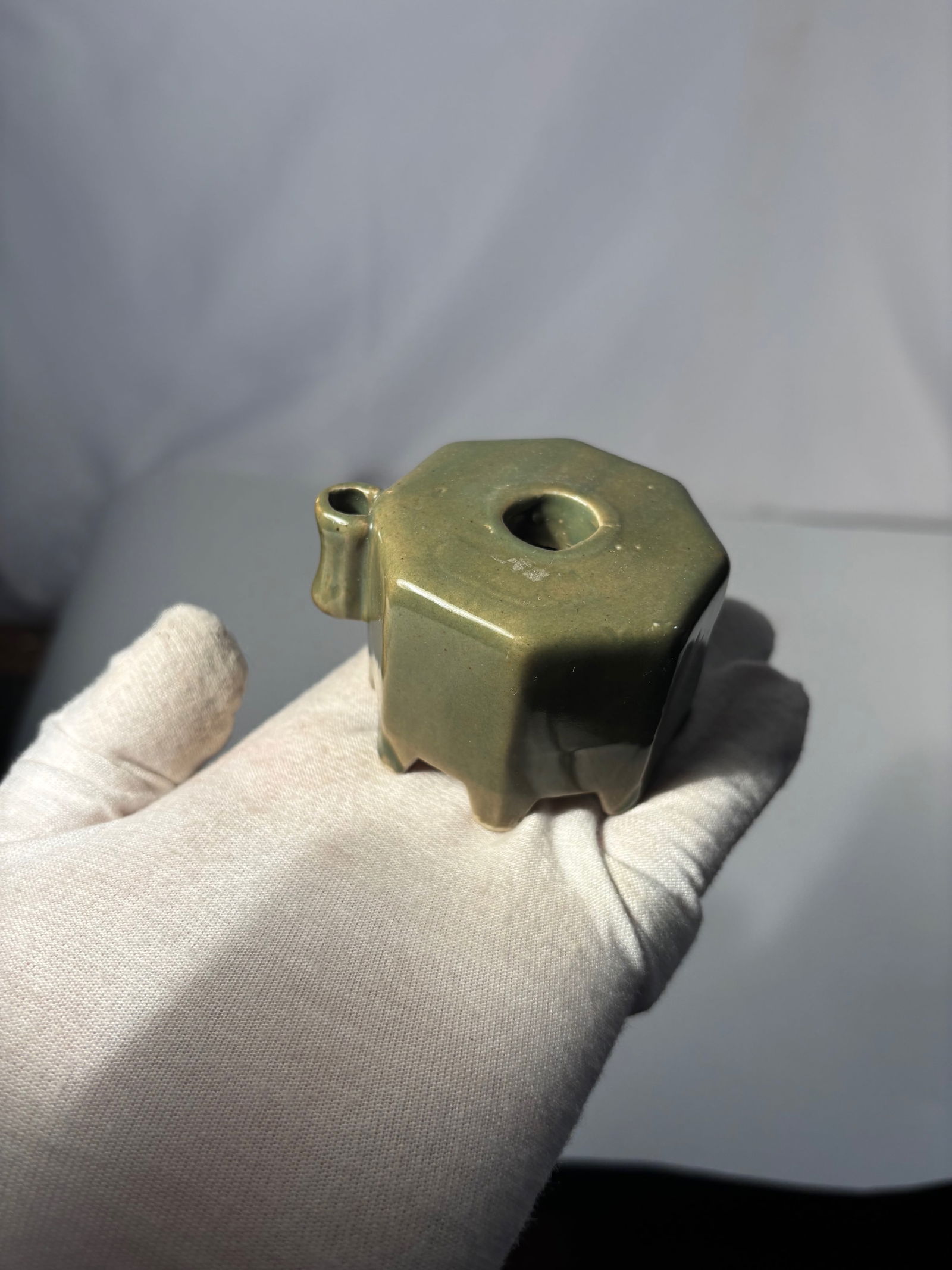 A Japanese Celadon-Glazed Water Dropper (Suiteki): 19th century , A Japanese celadon-glazed water dropper (suiteki), made for use in the scholar’s studio when preparing ink for calligraphy or painting. The small vessel is formed with a rounded body