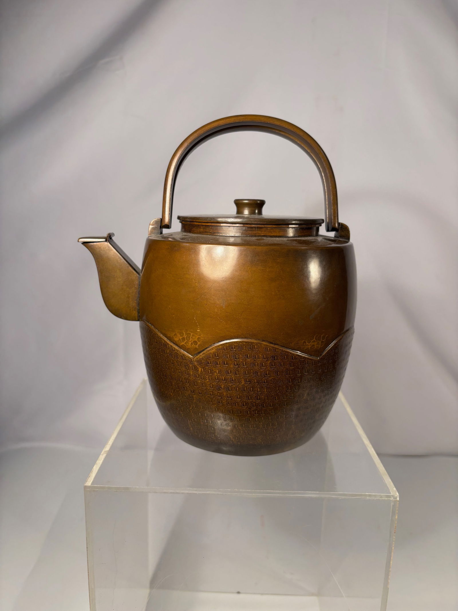 A Japanese Signed Metal Teapot (Yakan) with Wooden Storage Box (Edo–Meiji Period , 1850-1900): A Japanese metal teapot (yakan), likely dating to the late Edo to Meiji period. The vessel features a rounded body with an integrated spout and a fixed arched handle, showing a warm brown patina devel