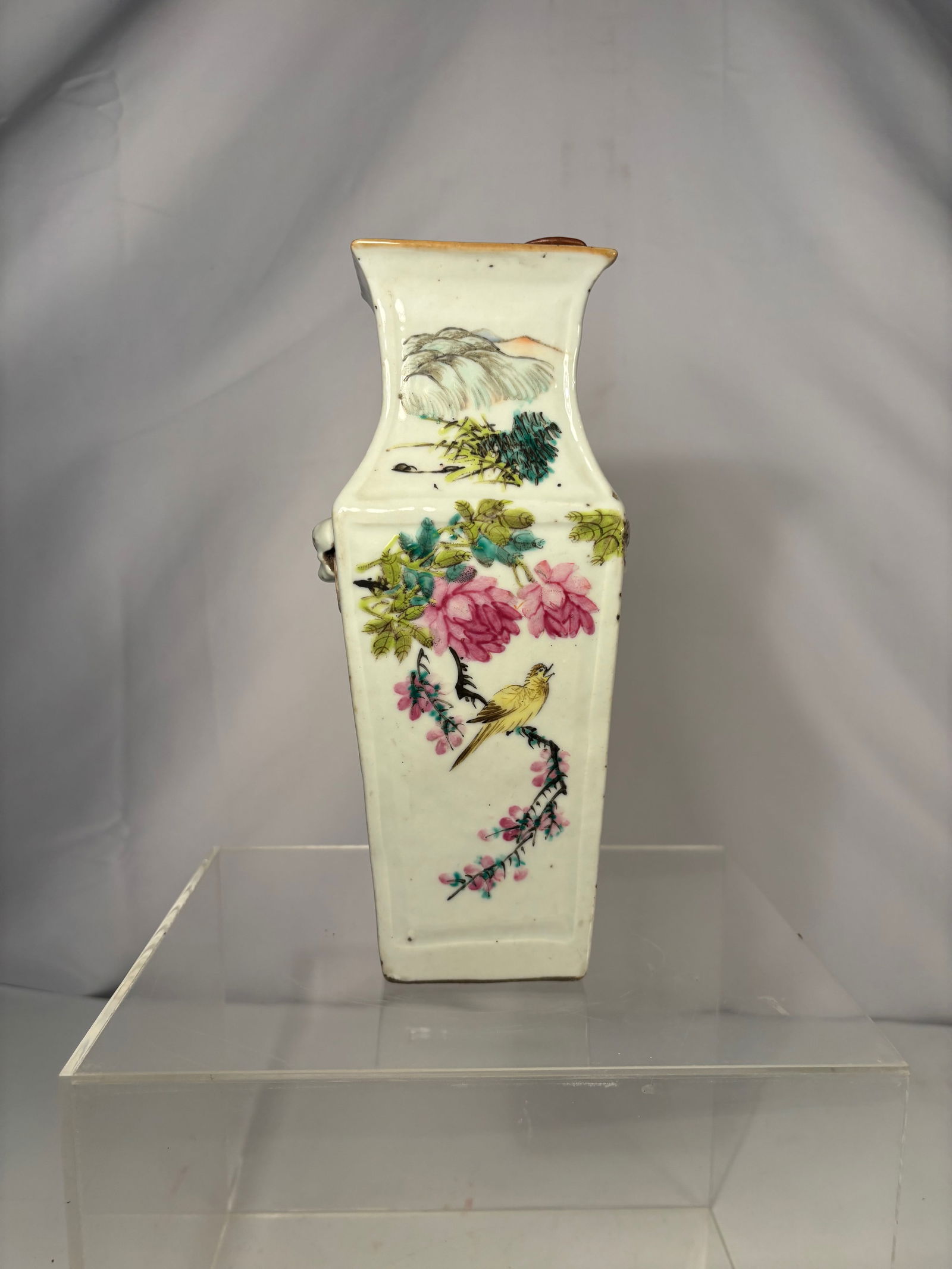 A Chinese QIANJIANG Porcelain Vase with Figures and Floral Decoration: Qing Dynasty (1644-1912) , Chinese porcelain vase of square form with gently flaring mouth, finely decorated in famille rose enamels. The exterior features hand-painted scenes including a scholar figu