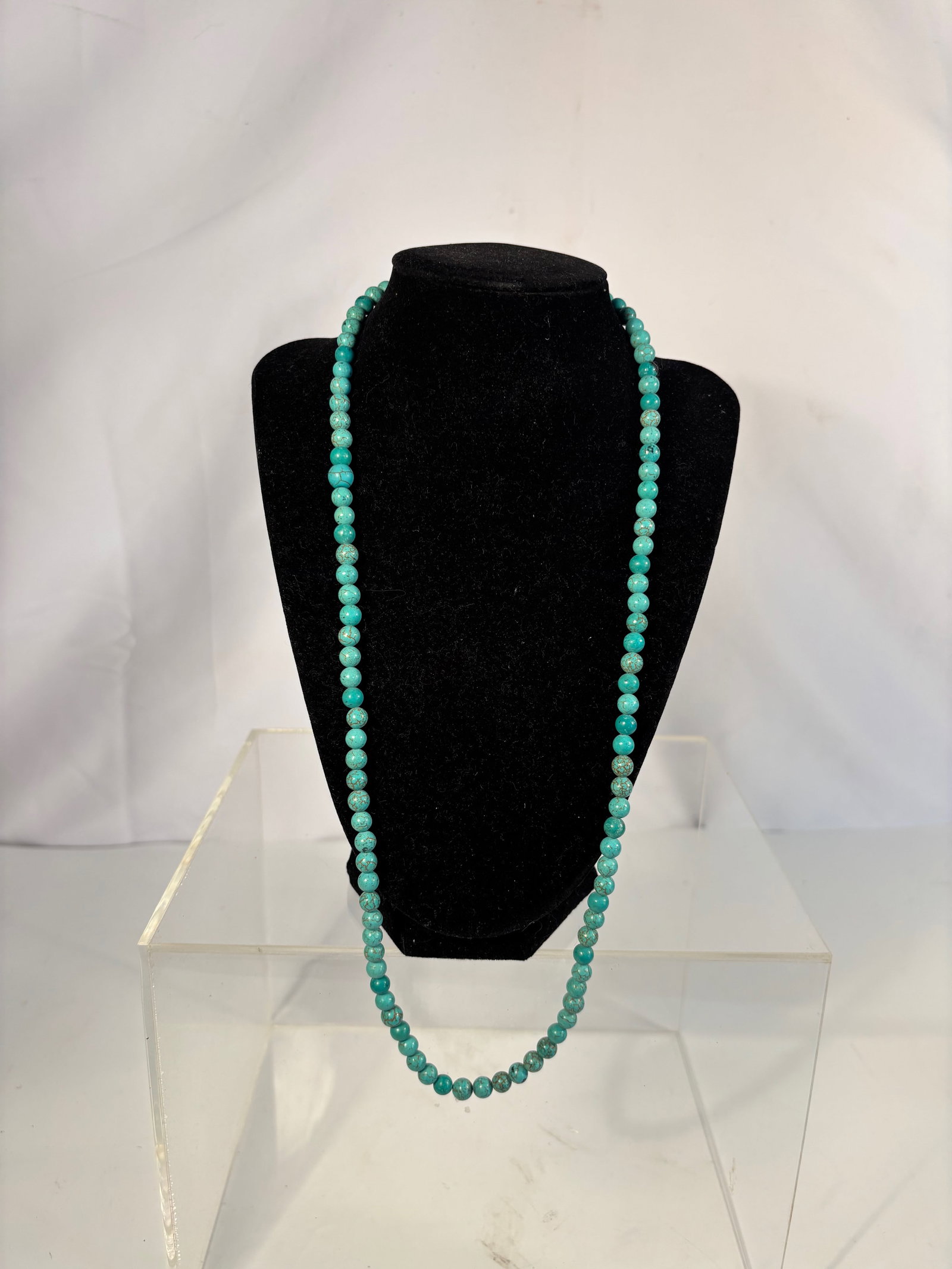 A Round Turquoise Bead Necklace with Gold-Tone Star Charm, 27 Inches, 1.35 oz: A classic single-strand necklace composed of round turquoise beads showing attractive blue-green coloration with natural brown matrix veining, completed with a small gold-tone star charm accent. The n