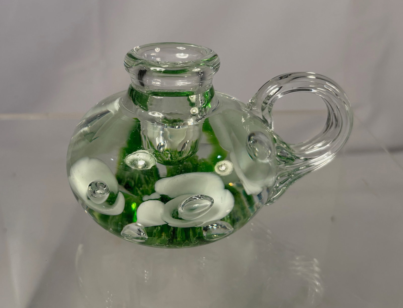 St. Joe Claire Art Glass Miniature Candle Holder: St. Joe Claire art glass miniature candle holder, featuring green and clear glass with applied decorative elements and controlled bubble inclusions. The piece is molded to the base “St. Joe Claire.&