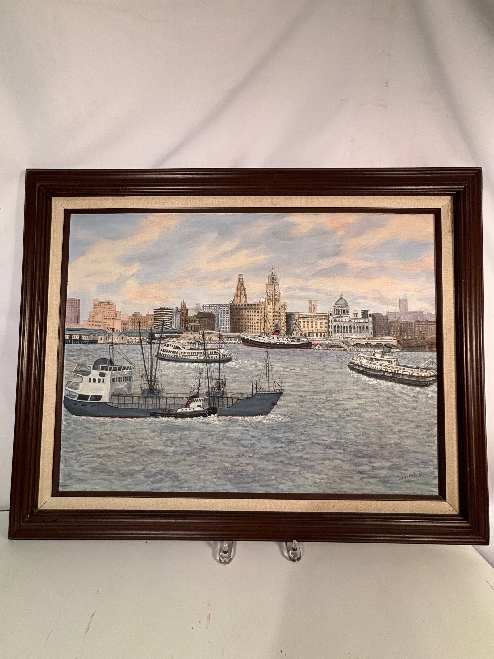 Mid 20th Century Liverpool Harbor Scene Oil on Canvas, Signed “LAYINIA W: Oil on canvas harbor scene depicting the Liverpool waterfront with steamships and ferries set against the iconic Pier Head skyline, including the Royal Liver Building. Signed lower right. Size : 30 x
