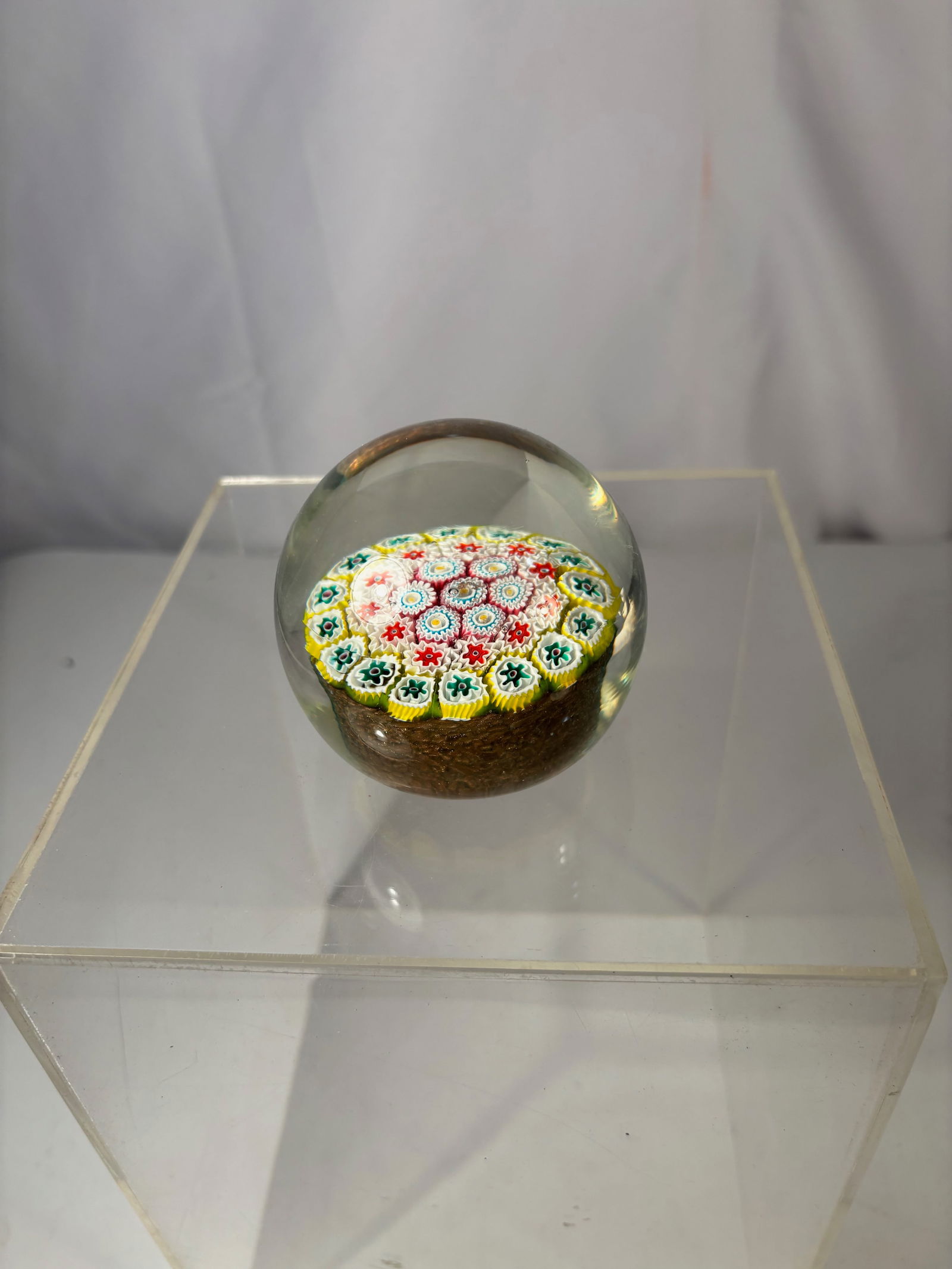 Art Glass Millefiori Paperweight with Multicolor Concentric Cane Design: Decorative art glass paperweight featuring a classic millefiori design composed of tightly packed multicolor canes arranged in a concentric circular pattern. The vibrant palette includes red, yellow,