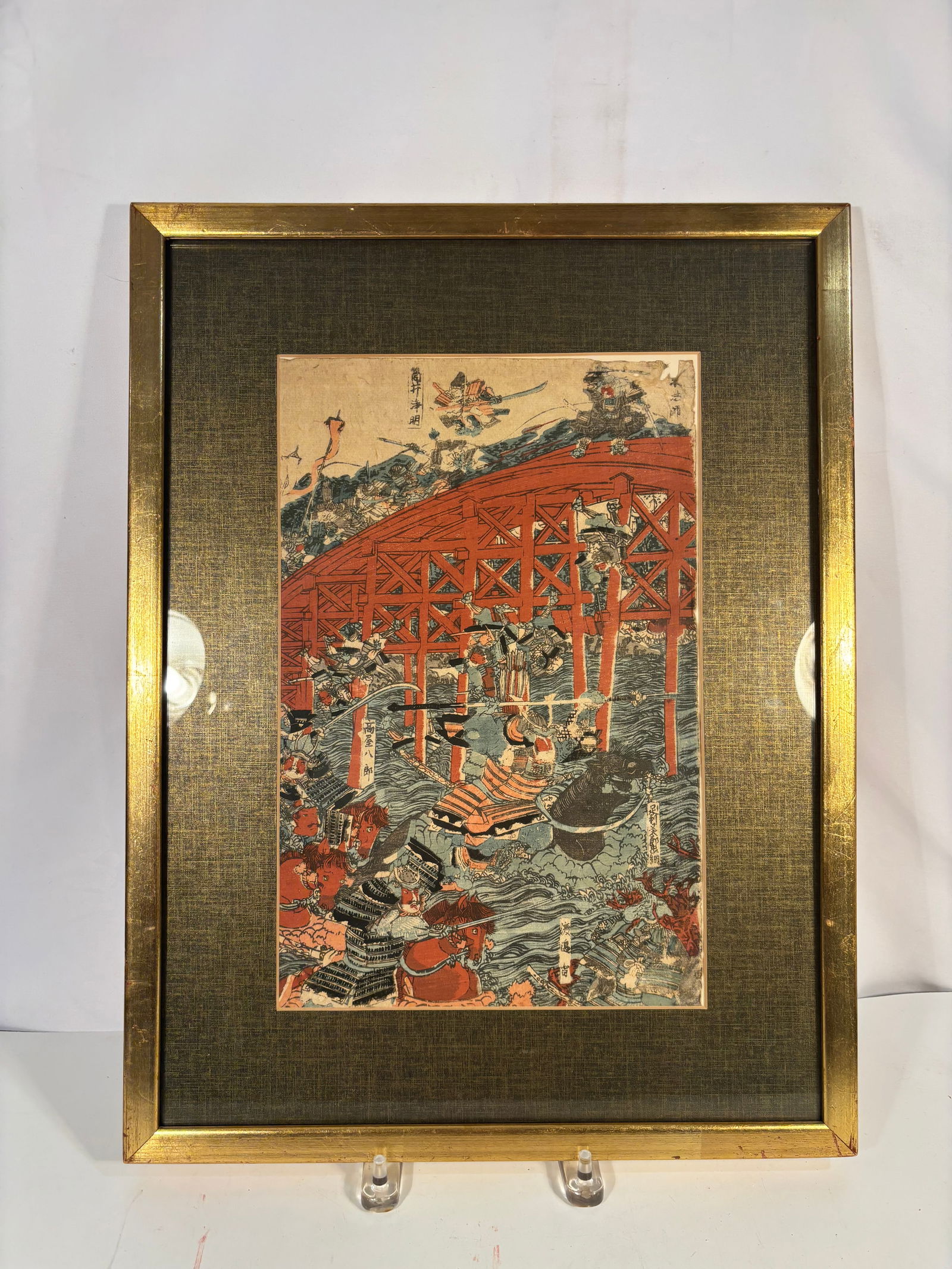 A Framed Japanese Edo Ukiyo-e Woodblock Print, Utagawa Sadahide, Battle of Uji Bridge: Japanese ukiyo-e color woodblock print by Utagawa Sadahide (1807–1873), depicting the famous Battle of Uji Bridge from the Genpei War, circa 1847–1848 (late Edo period). The dramatic composition s