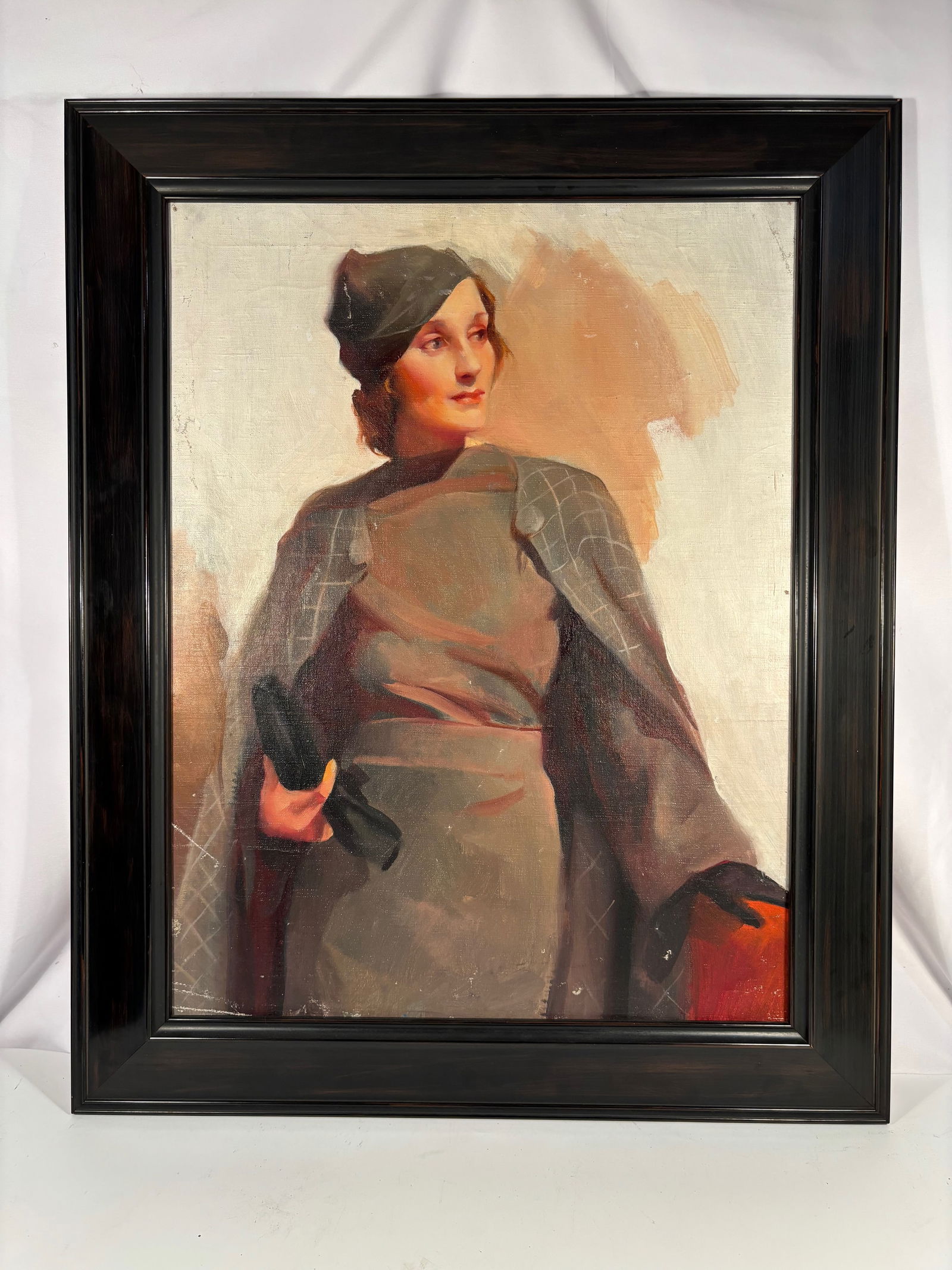 An Oil on Canvas Portrait of a Young Woman in Cap and Cloak: Oil on canvas portrait depicting a young woman wearing a dark cap and draped cloak, rendered in a realist manner with warm tonal modeling and soft highlights. The sitter is shown standing three-quarte