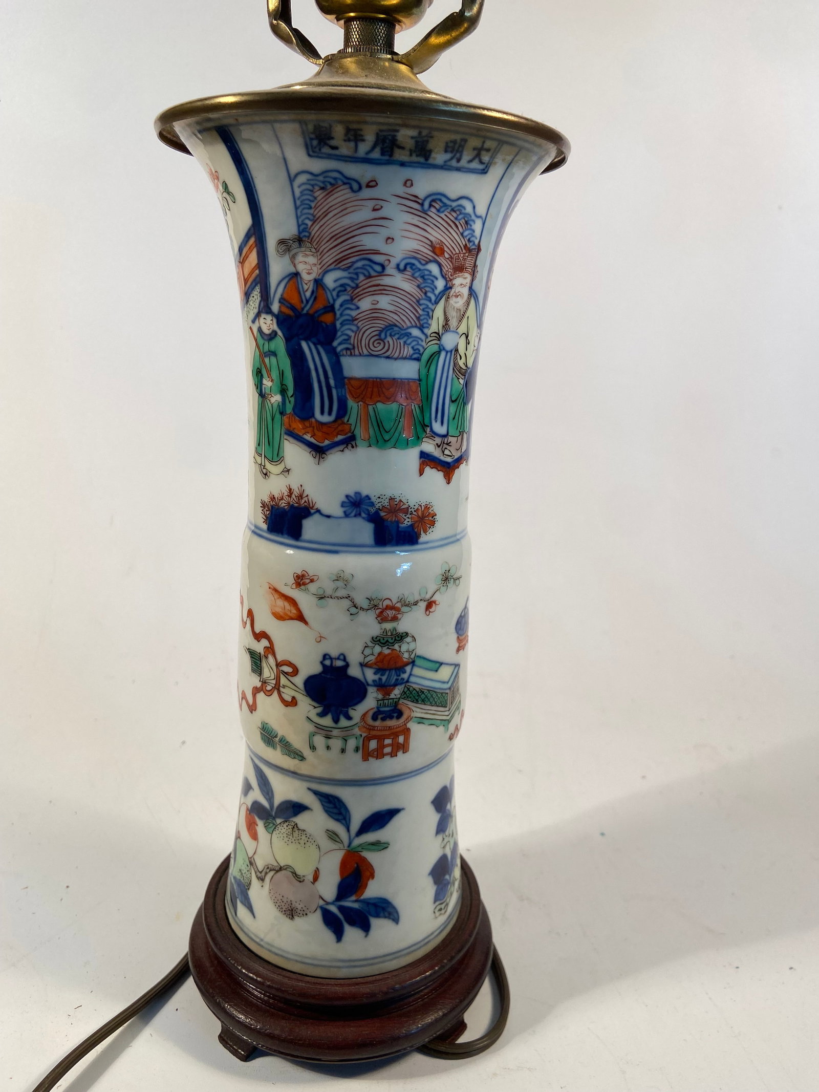 A Chinese famille rose porcelain lamp with WanLi Six-Character mark: Qing dynasty (1644-1912); The vase features traditional Chinese motifs, with painted scenes of figures, clouds, and other decorative elements. The use of bright colors, including blue, red, and green,