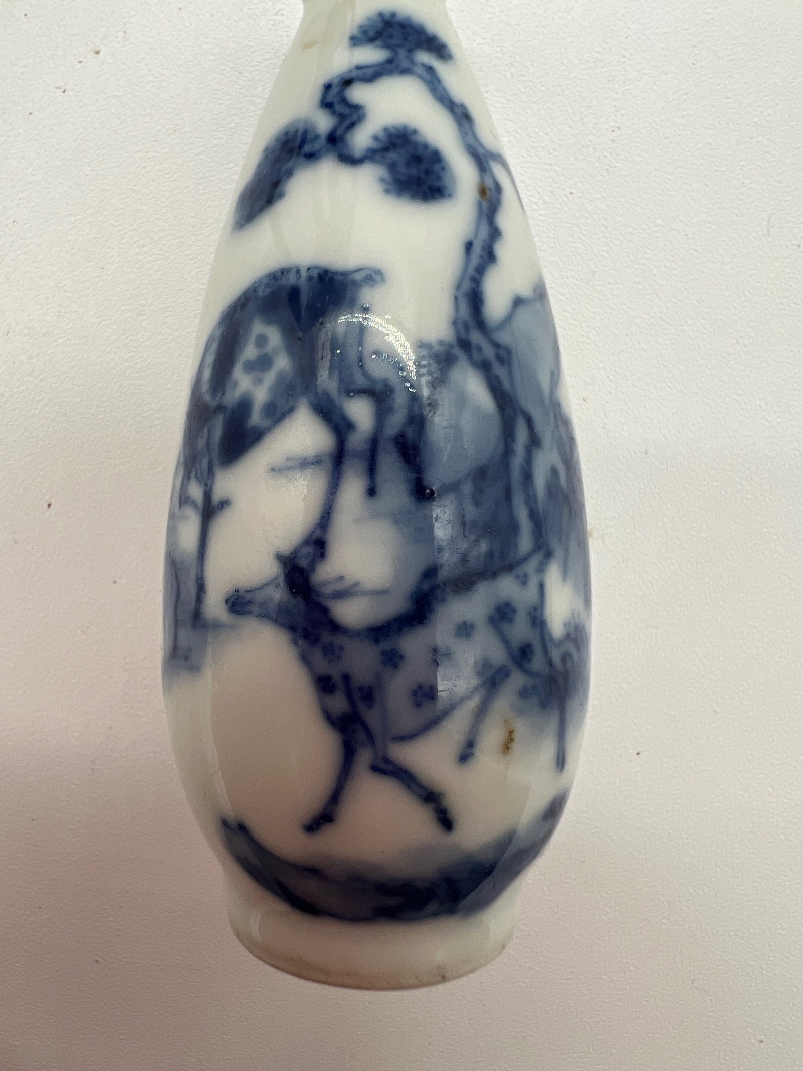 A Chinese blue and white porcelain hand painted snuff bottle: Qing Dynasty (1644-1912); The snuff bottle features two deers , pine tree and mountain of the landscape scene. Dimensions?Height: 7.5 cm