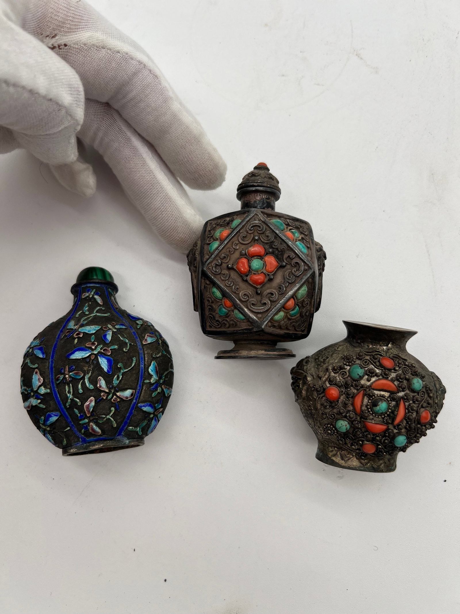 Three Chinese silver enamel snuff bottles with coral and turquoise inlays: Qing Dynasty (1644–1912) ,Dimensions? highest Height: 3 inches